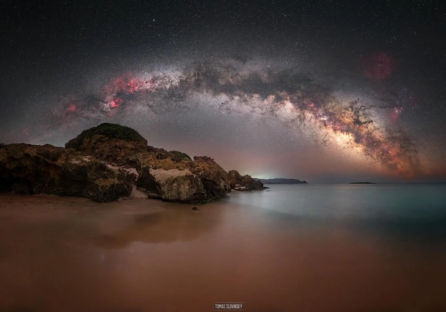 My Small Cretan Paradise ✨

In my small Cretan paradise, the night reveals its quiet magic.
Above the rocky shore, the Milky Way sparkles like a luminous river across the sky, stretching from horizon to horizon. Countless stars shimmer on the dark sk