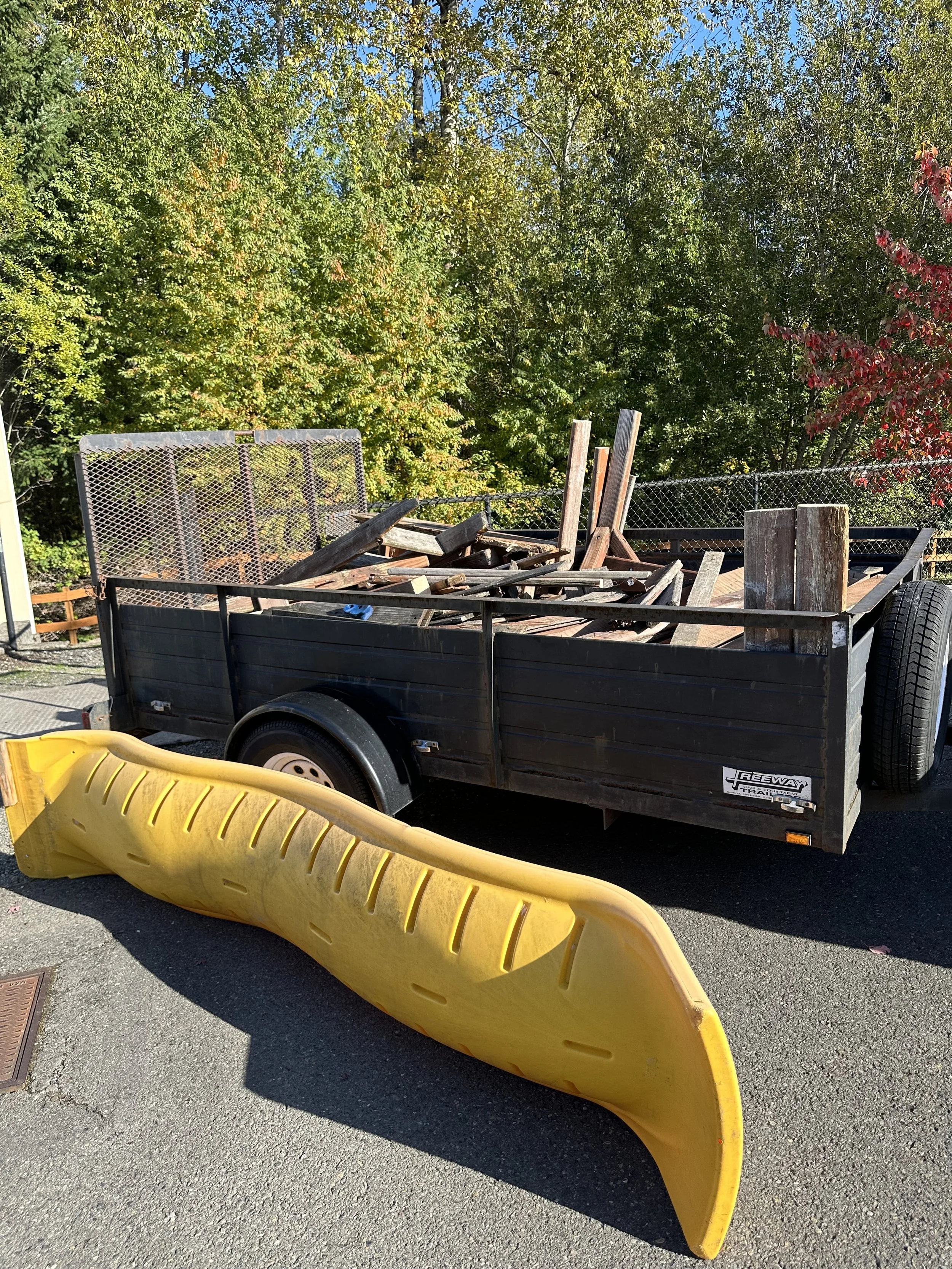 After tear-out — Final trailer load with all wood debris and the playground slide ready for haul-off, Tacoma WA.