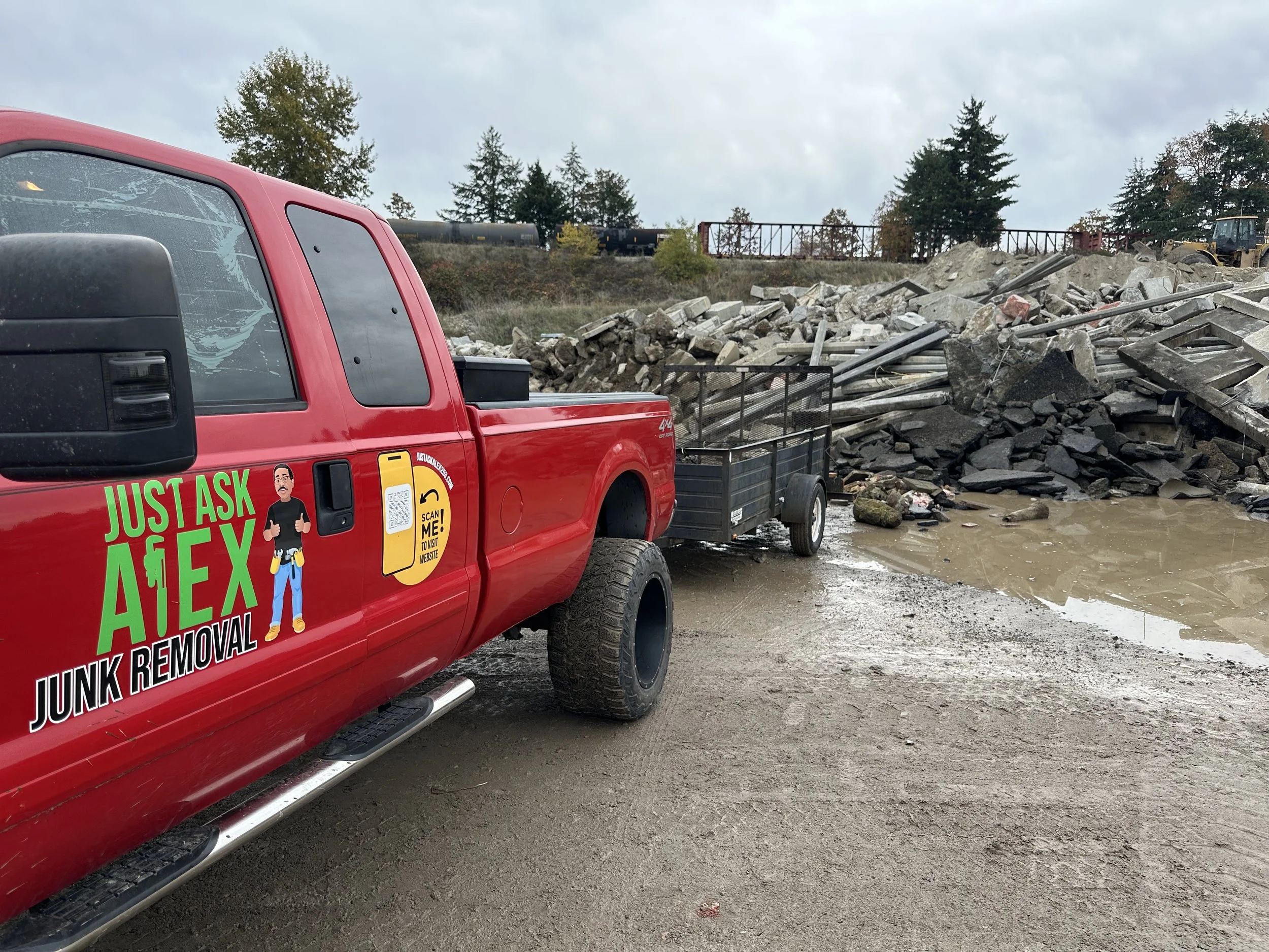 Just Ask Alex Junk Removal truck and trailer unloading concrete for recycling at Randles Sand and Gravel in Puyallup, WA.