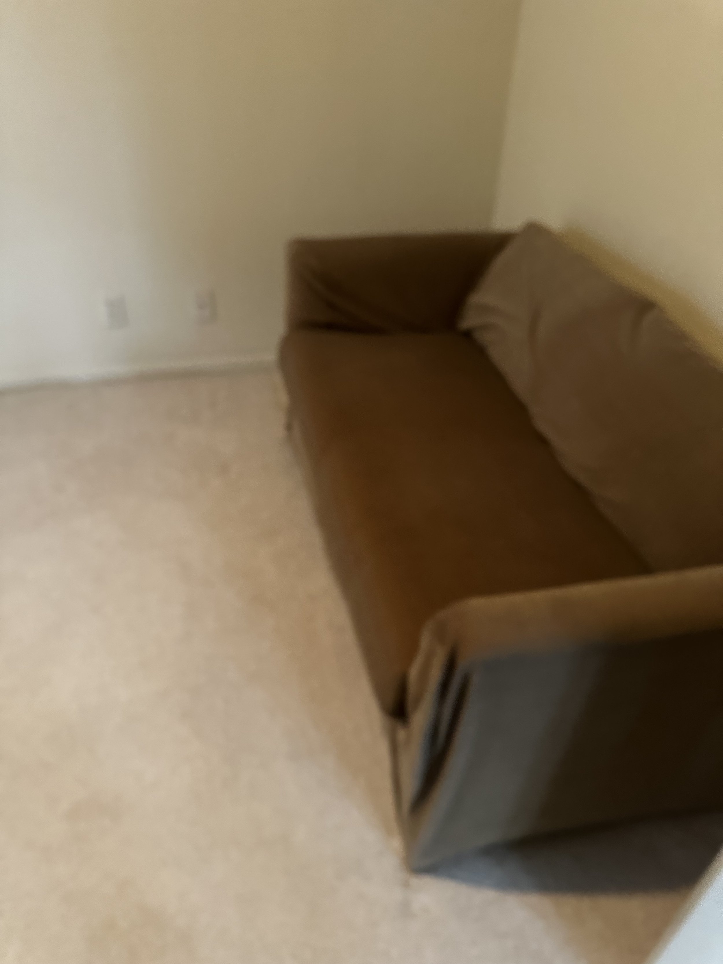 Before — Small loveseat left behind during the move-out.