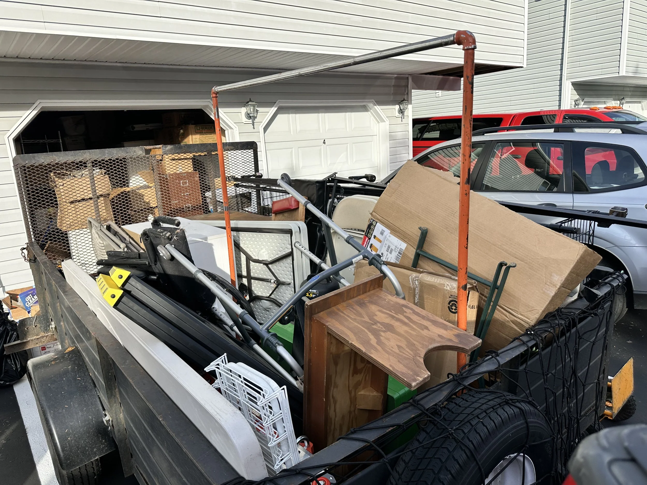 Loaded junk removal trailer filled with furniture, boxes, and household items during a garage clean-out in Puyallup, WA.