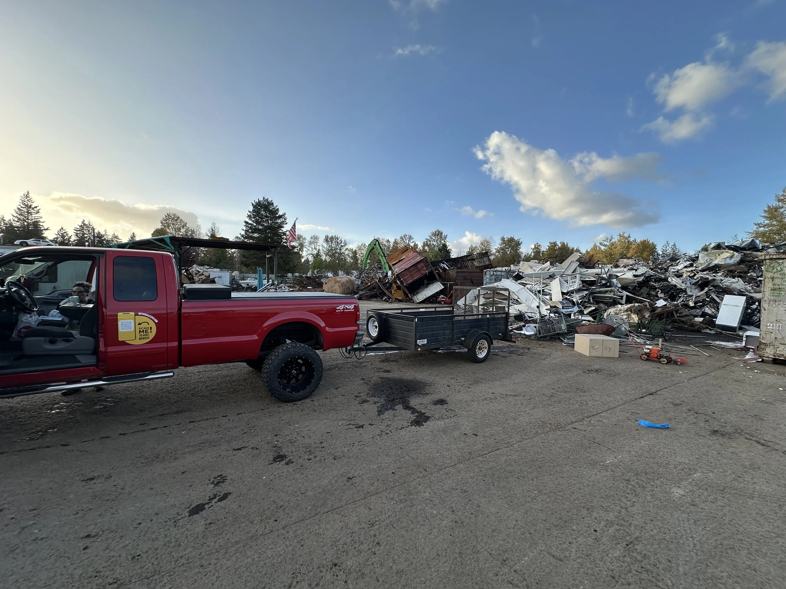 Just Ask Alex Junk Removal truck unloading mixed metal and construction debris at Recycling Resources in Tacoma, Washington