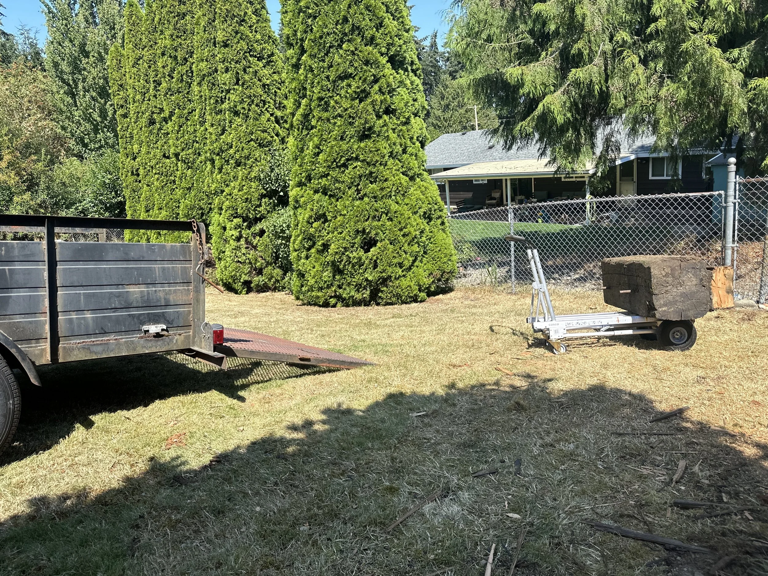 Loading — beams were too heavy to carry, so a hand truck was used to roll them into the trailer.