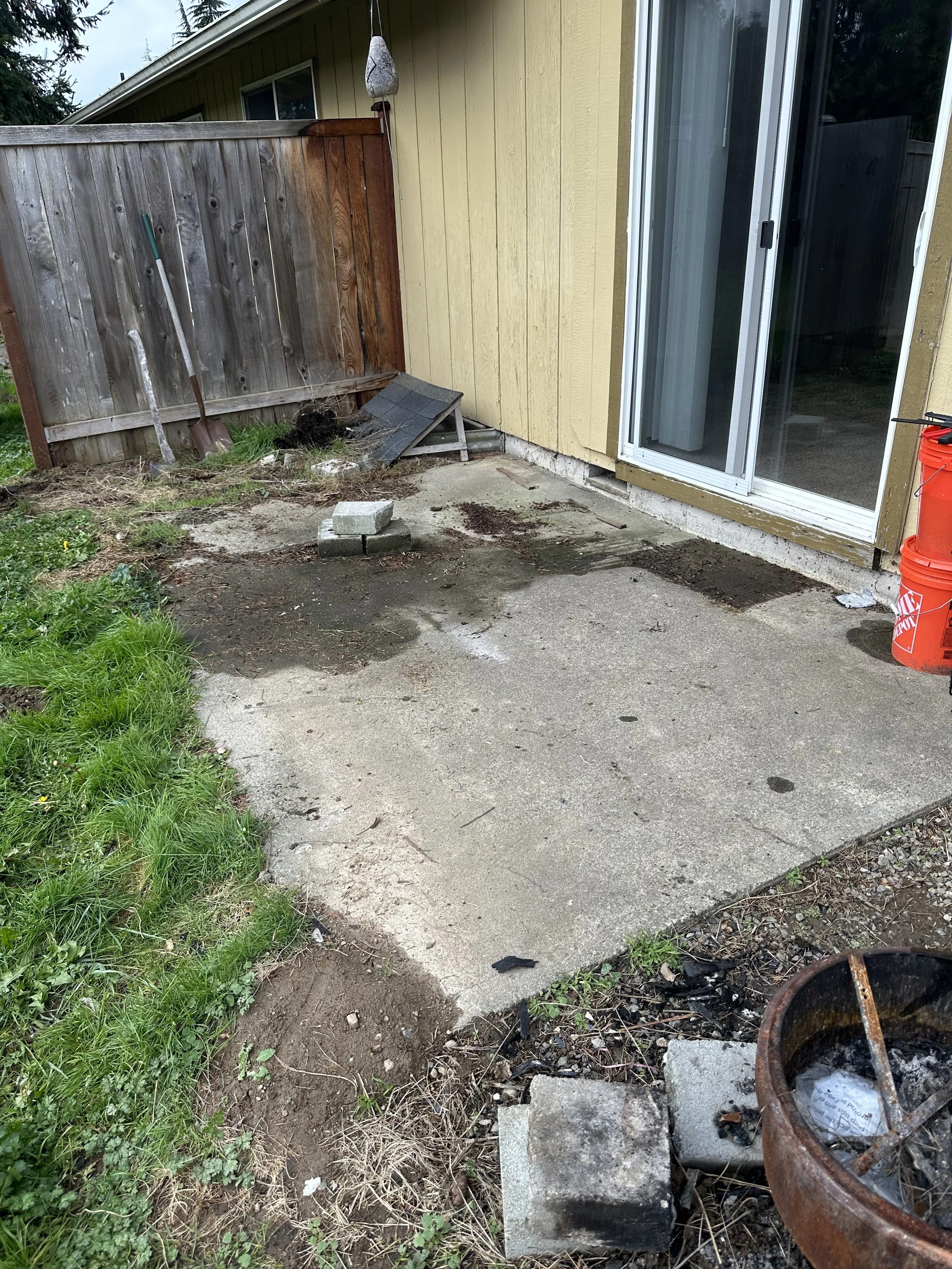 Back patio fully cleared after yard waste and outdoor junk removal.