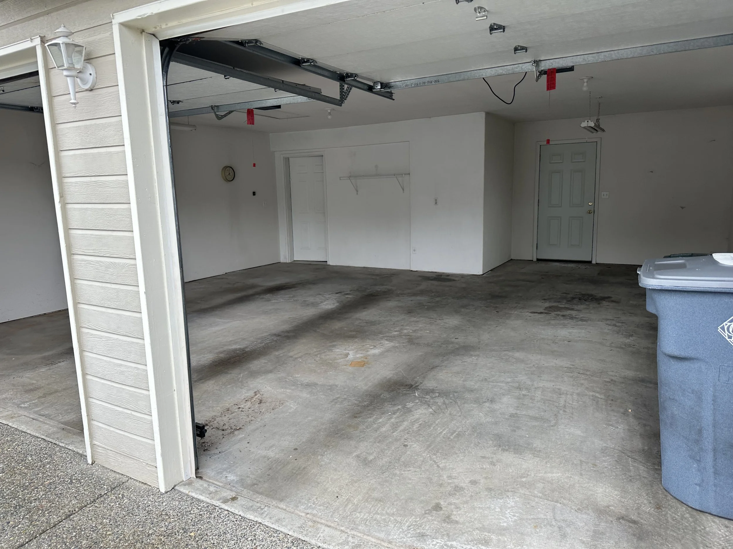 After — Garage fully cleared and swept out.