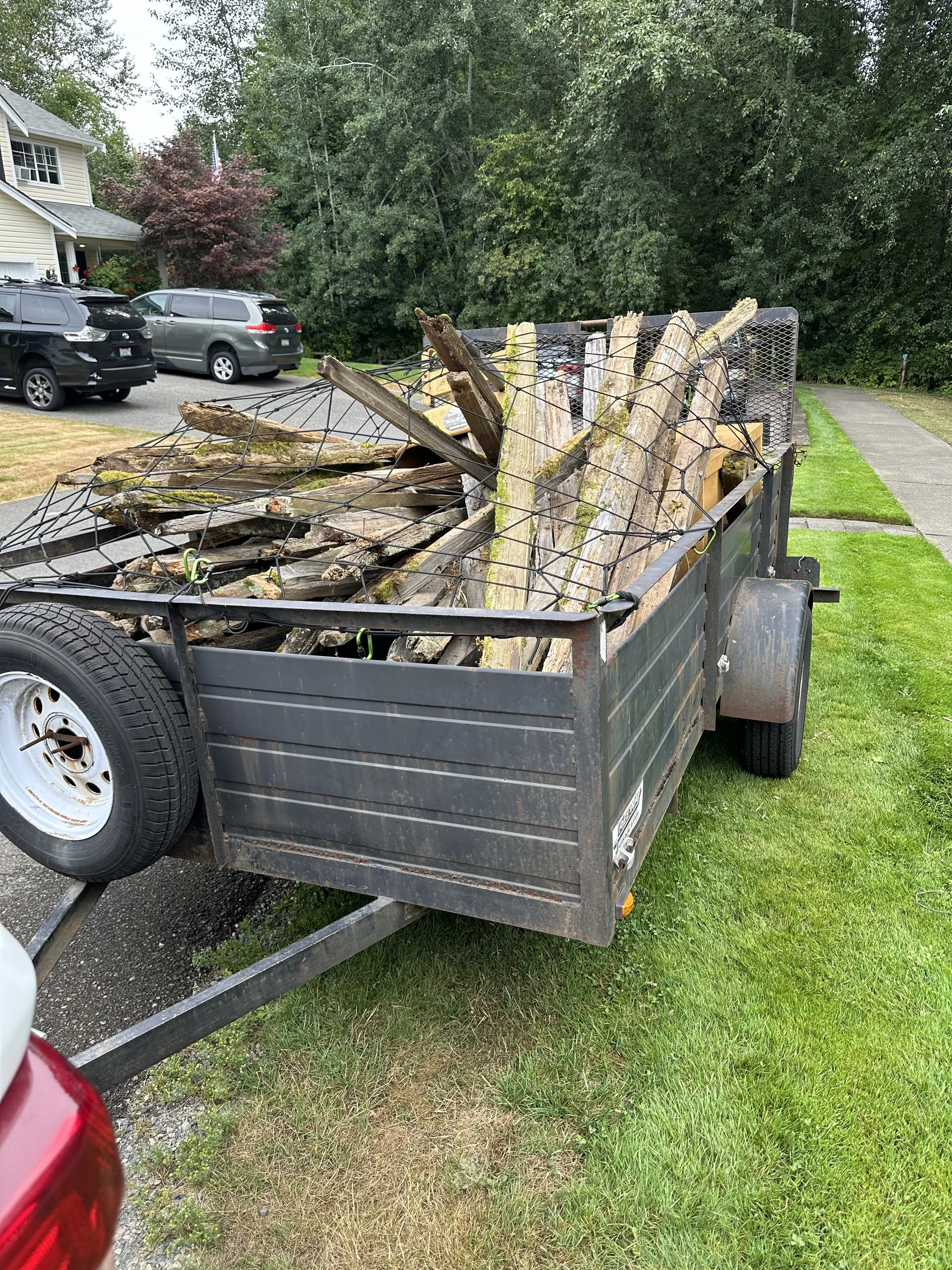 All fencing debris loaded and secured for haul-off — making space for the HOA’s new fence project.