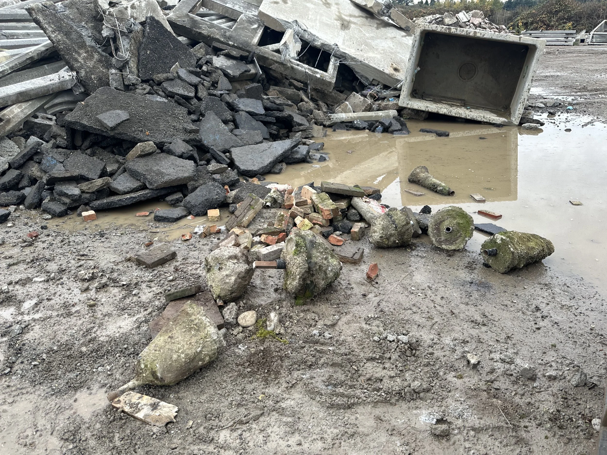 Concrete and demo rubble waiting for disposal — we sort, load, and drop it at the right facility. Tacoma, WA.