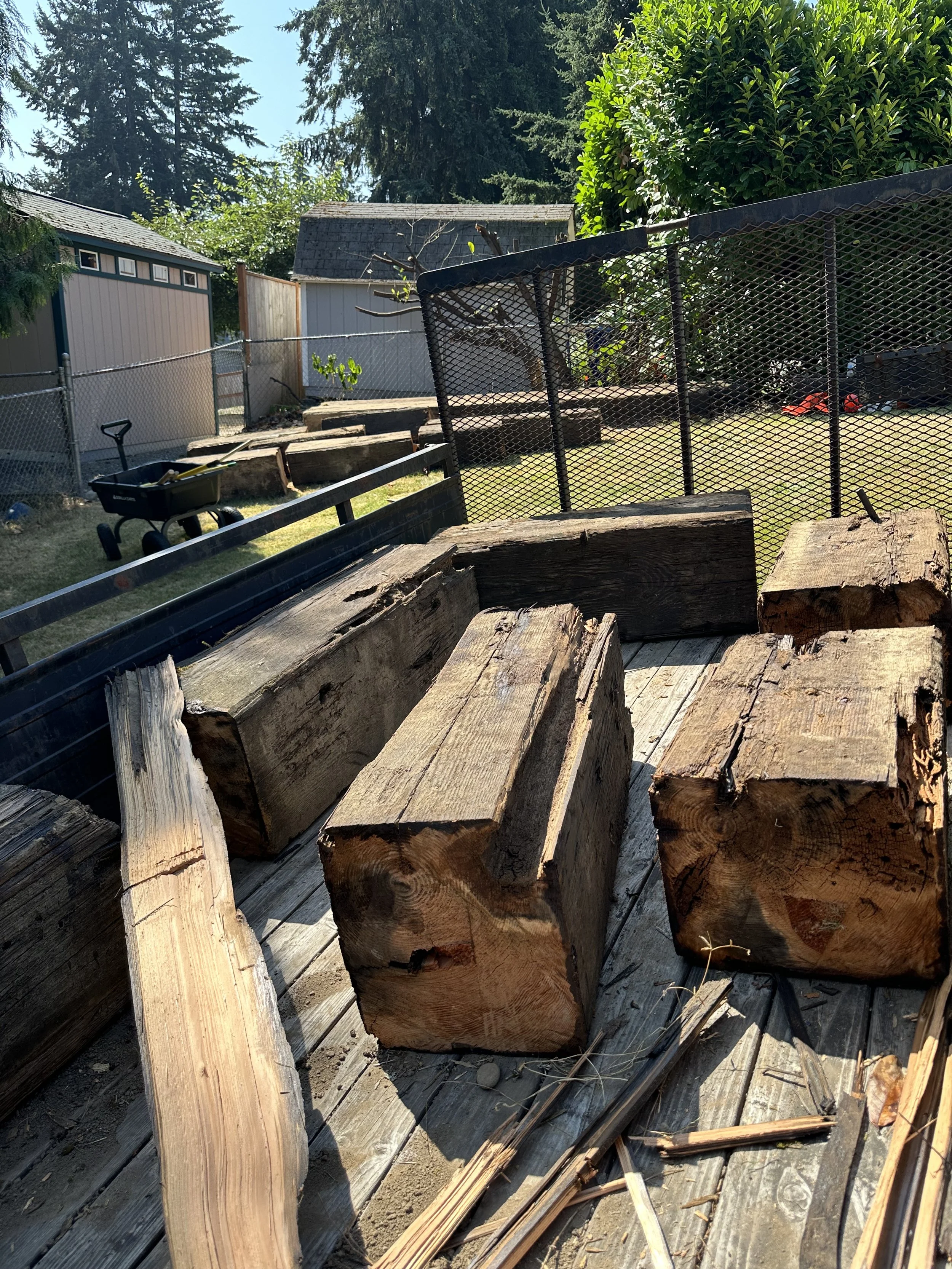 Loading — six beam sections loaded into the trailer, totaling roughly 1,500 lbs.