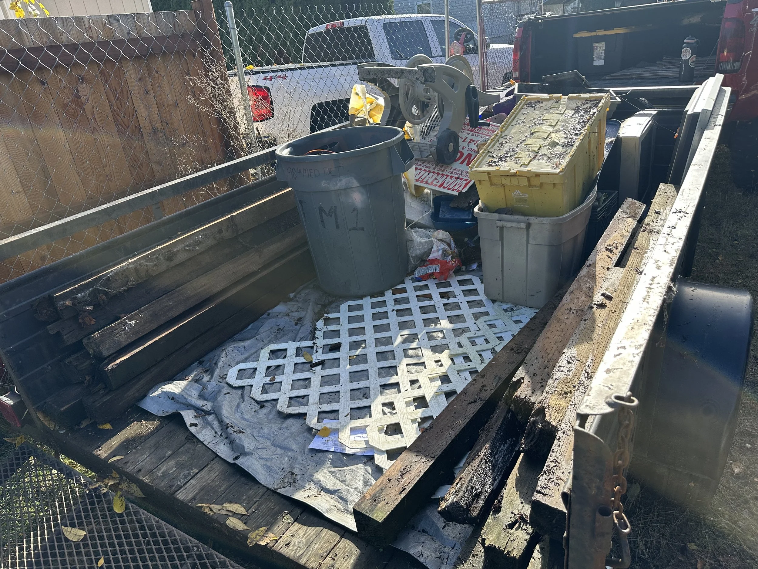 DAY 3 — Staging the first load of the day with bins, lumber, and loose trash.