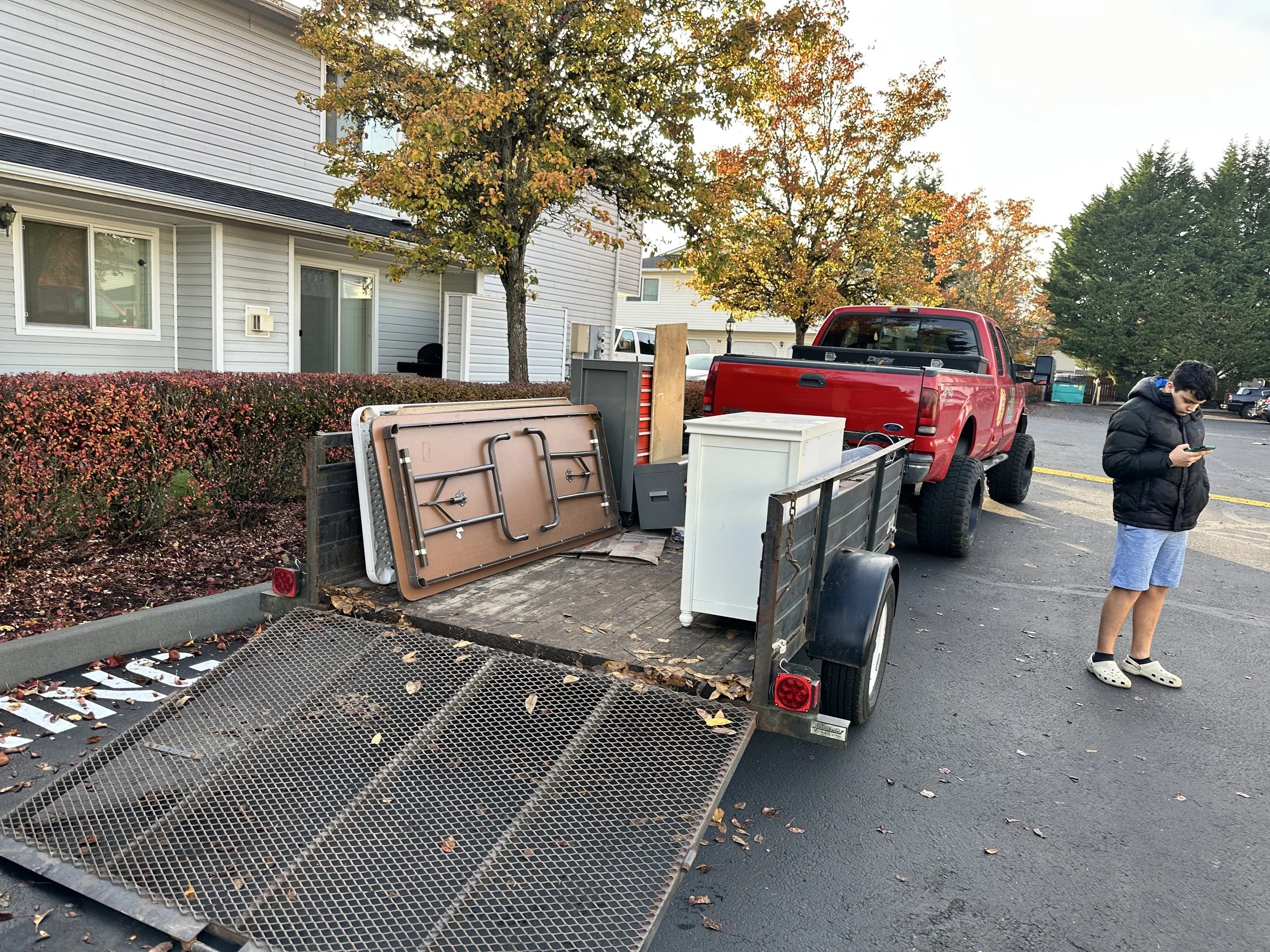 Junk removal trailer backed into position for loading during a large garage clean-out project in Puyallup, WA.