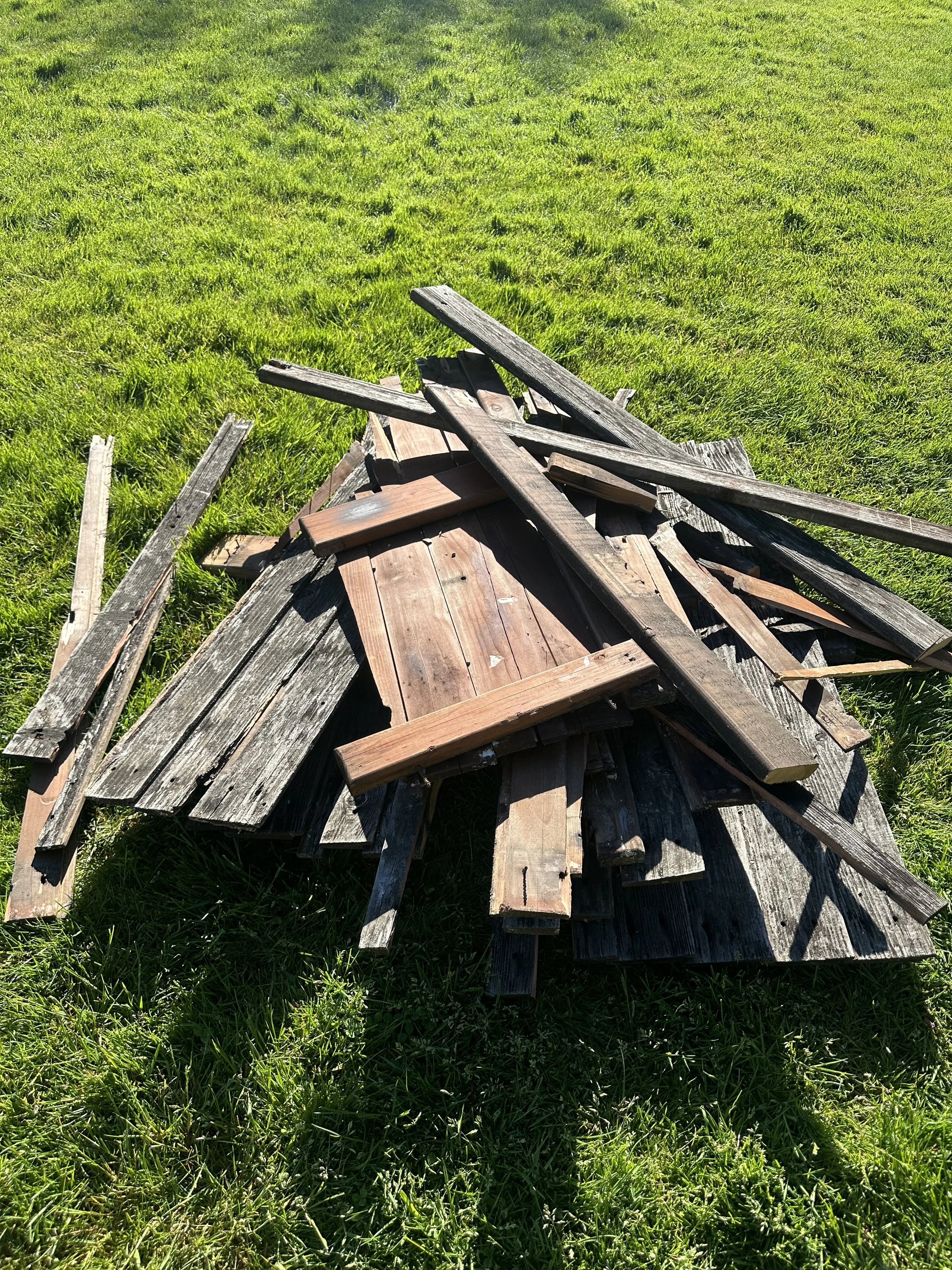 Tear-out progress — wood debris staged for haul-away, Puyallup WA.
