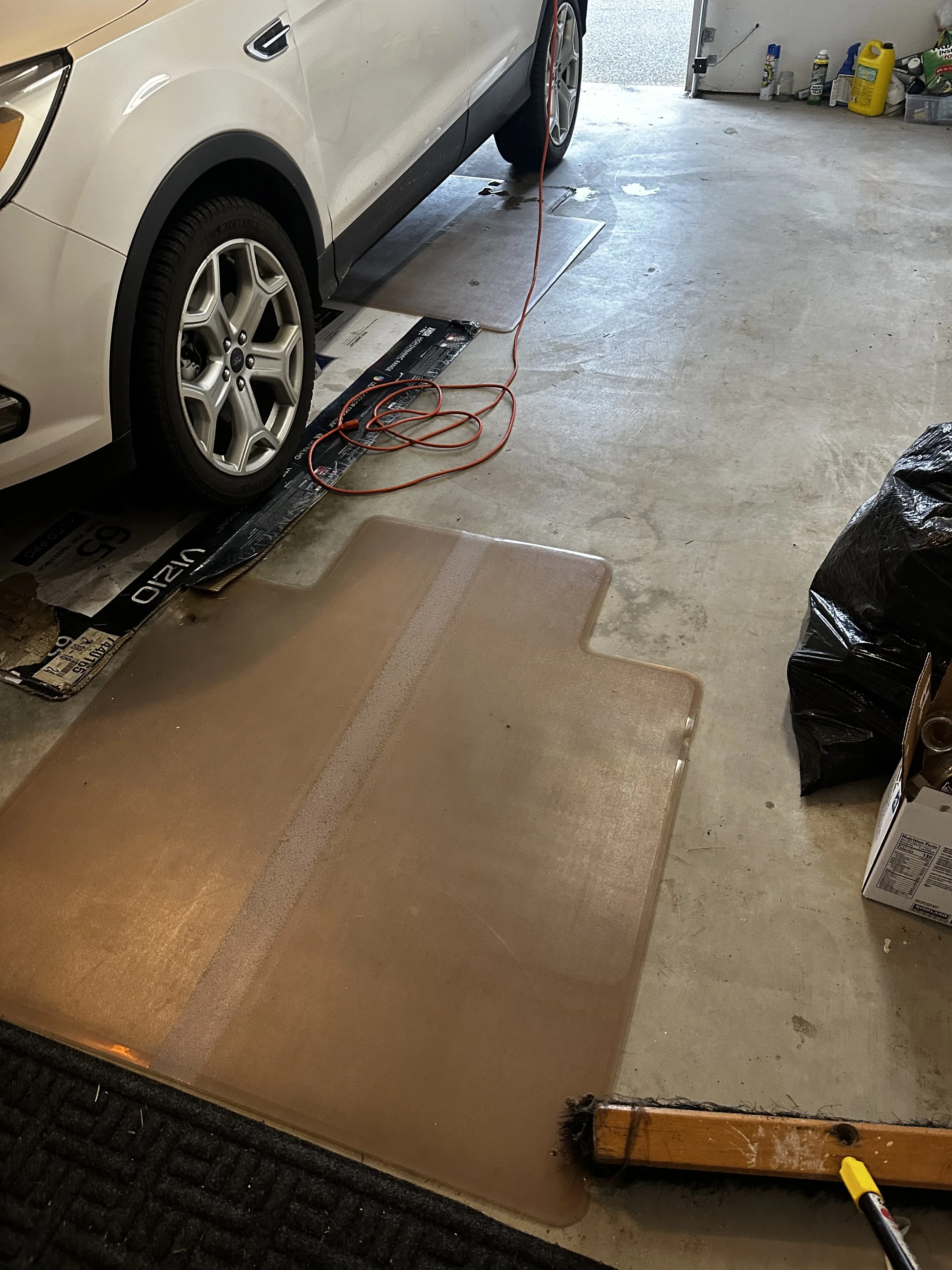 Before — Garage floor mats and misc debris.