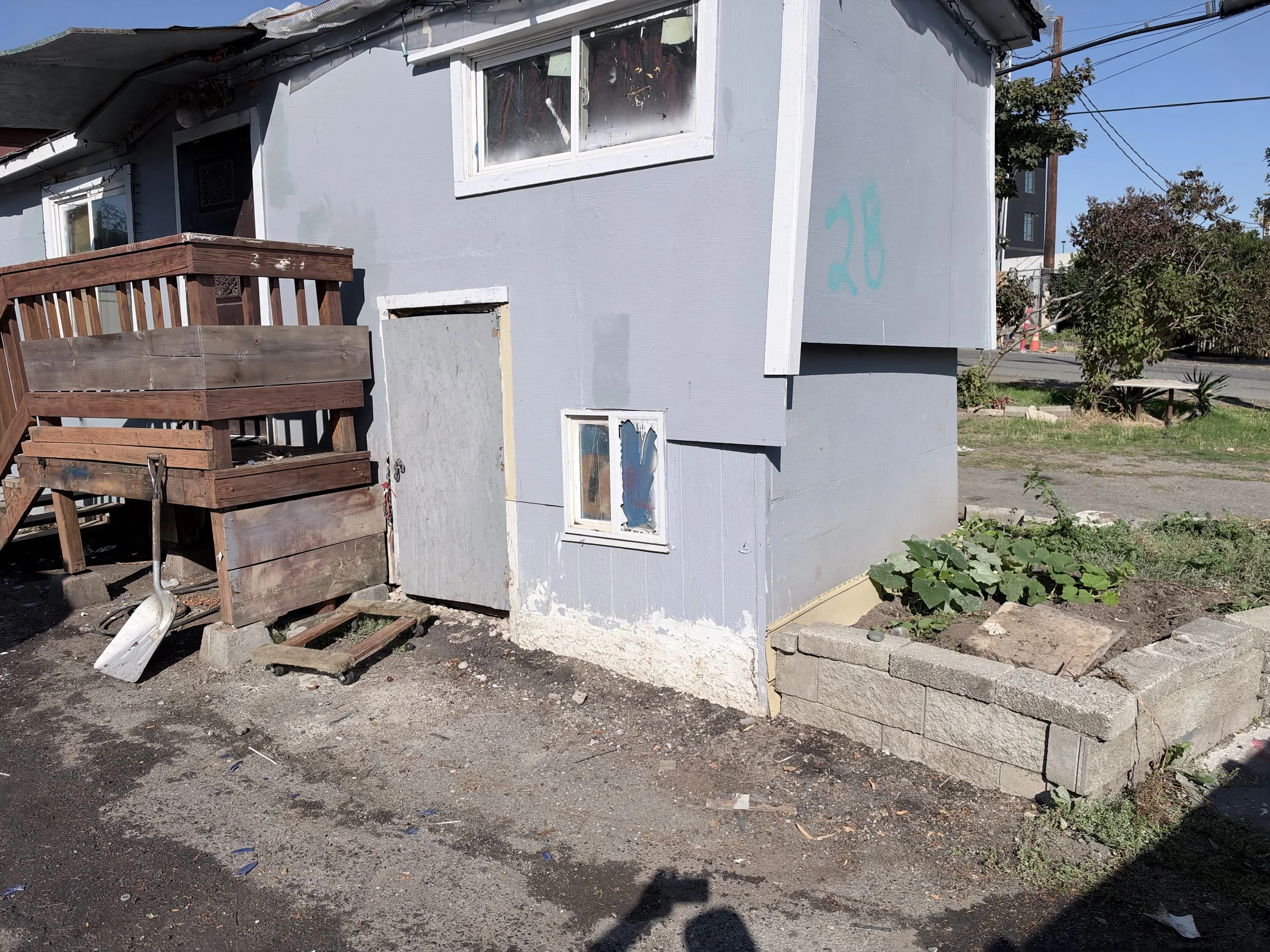 Cleared exterior area of a residential property in Tukwila, WA, after abandoned items were removed by Just Ask Alex.