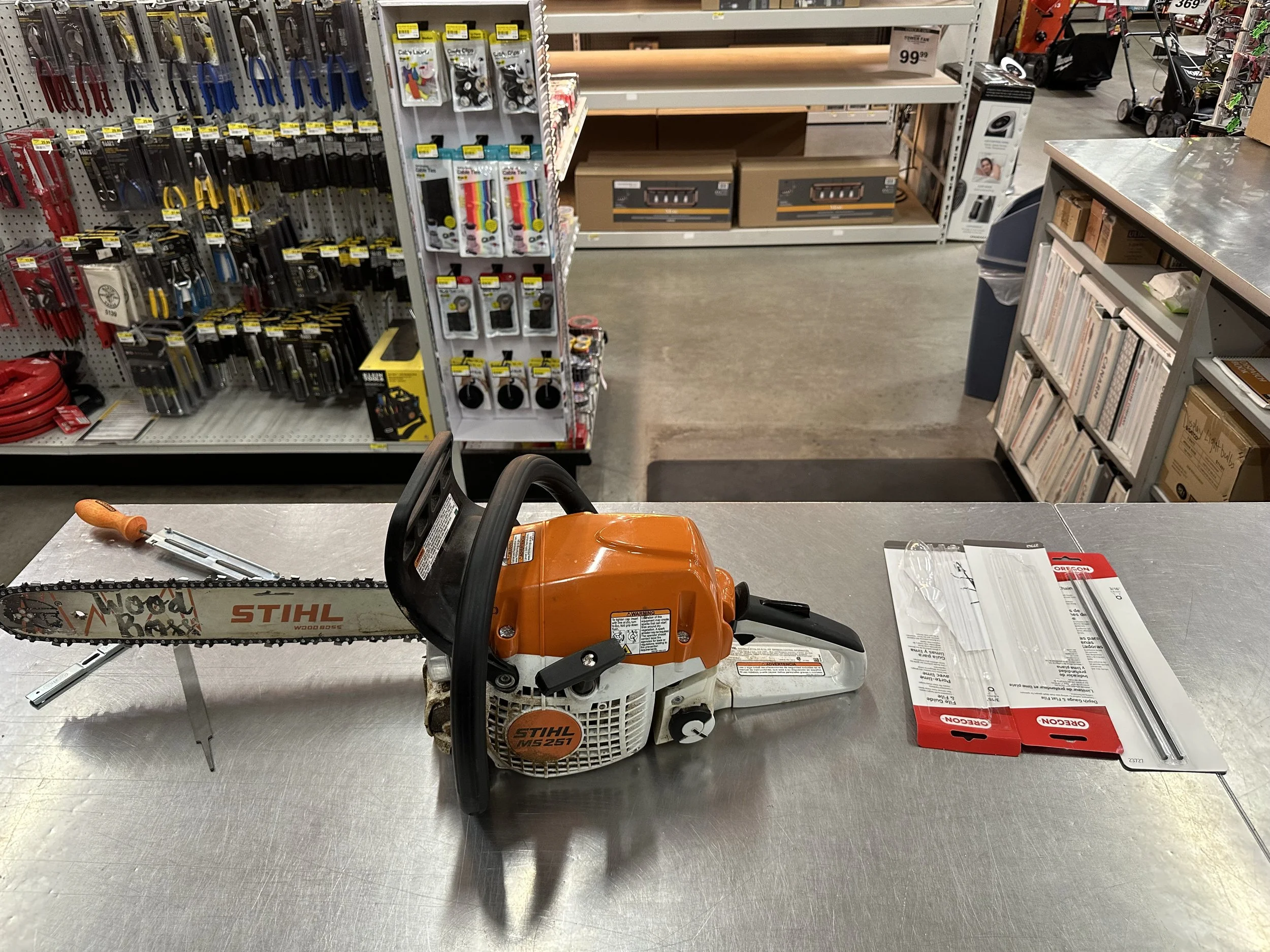 Before tear-down — sharpening the Stihl chainsaw blade to prepare for cutting heavy beams.
