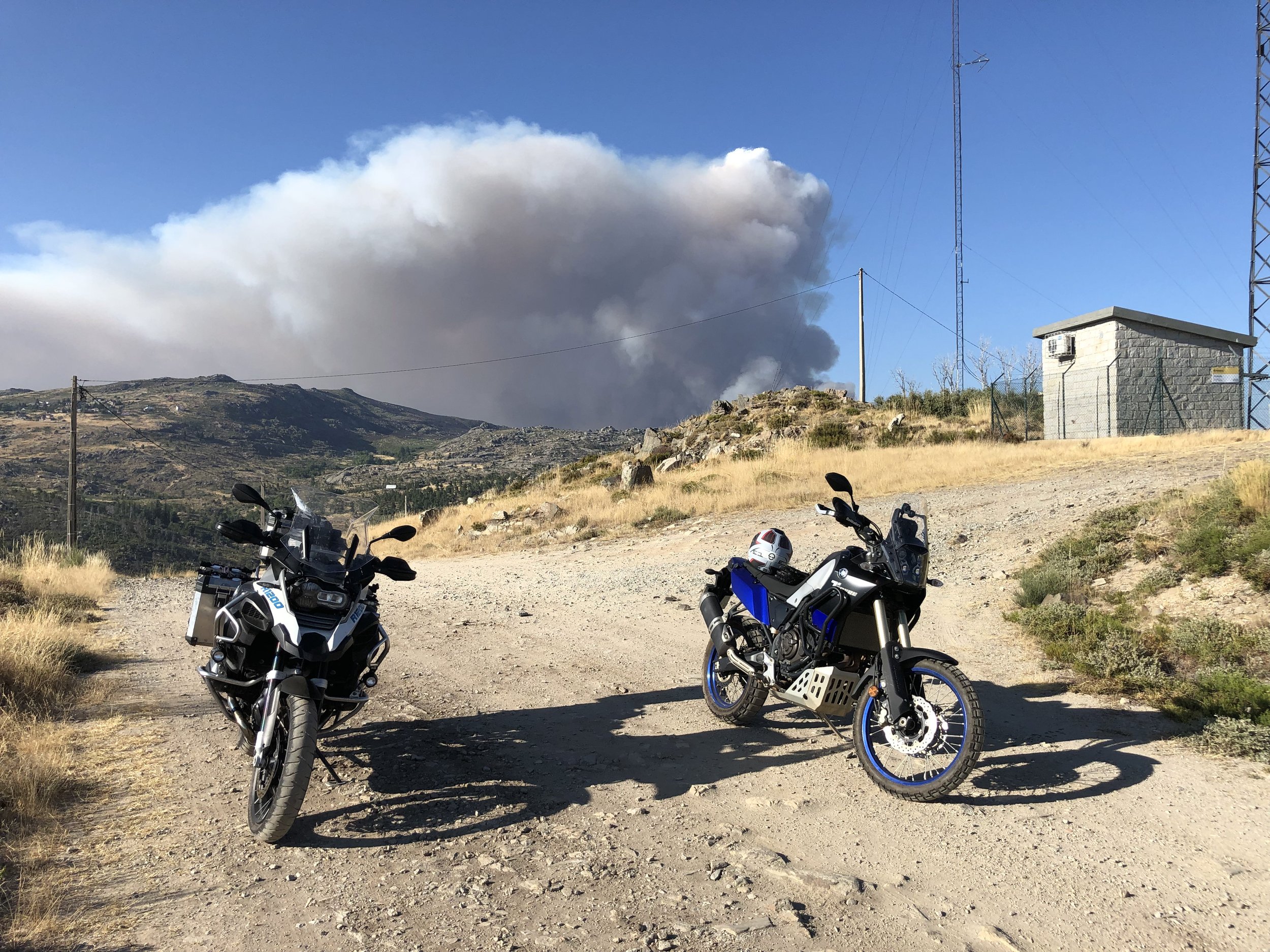 Two adventure motorcycles on a gravel hilltop track on the ACT Portugal route