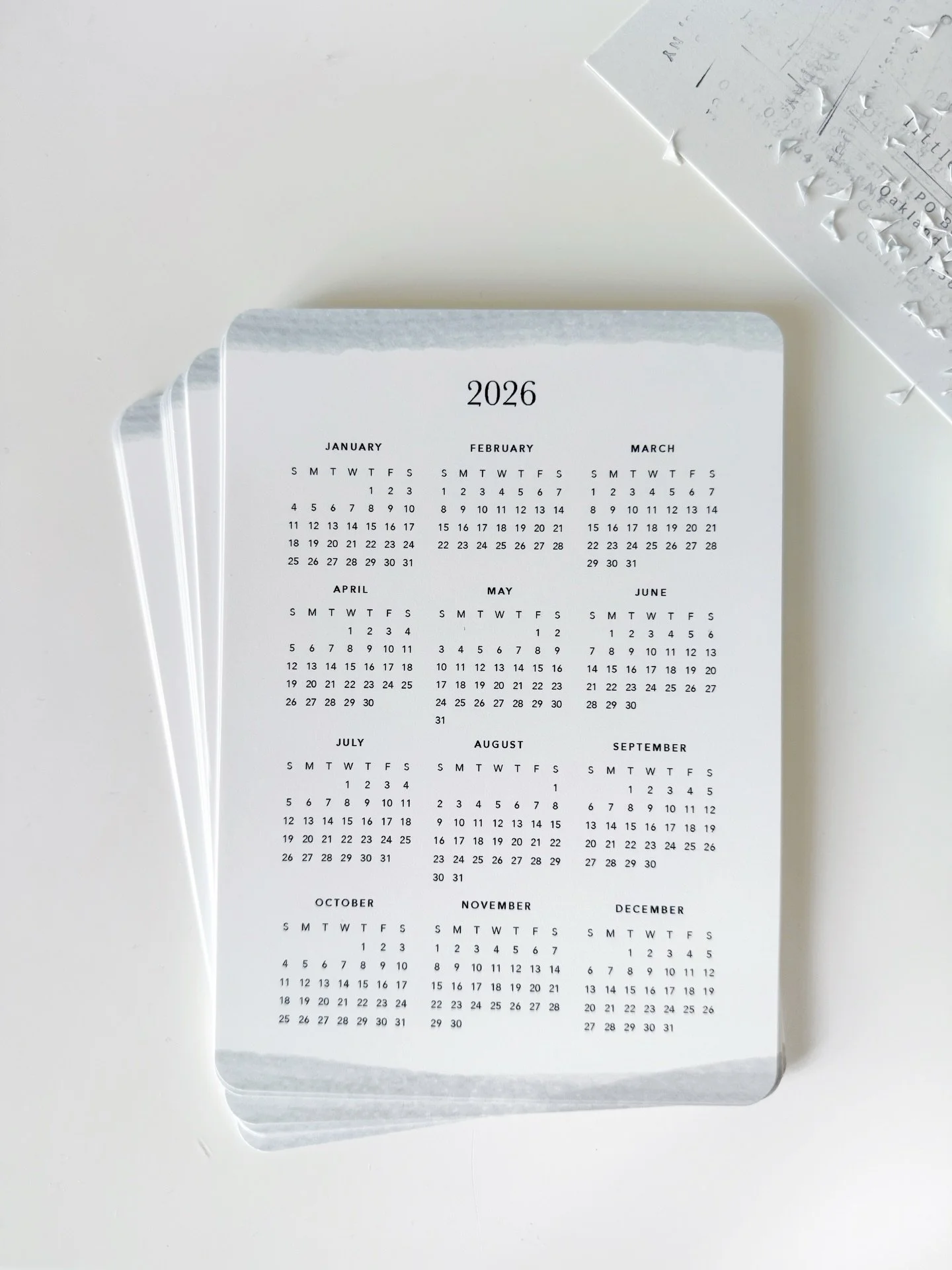 I made a 2026 year-view calendar for the Little Moments Journaling Club this month, and sat at my desk and punched all these rounded corners by hand.

I love the analog/handmade process of sending physical products via snail mail. A perfect excuse fo
