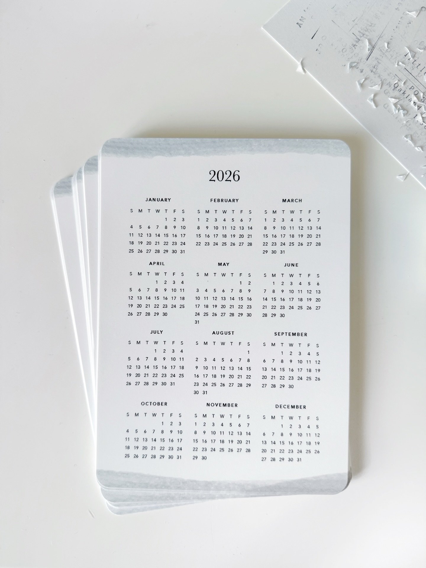 I made a 2026 year-view calendar for the Little Moments Journaling Club this month, and sat at my desk and punched all these rounded corners by hand.

I love the analog/handmade process of sending physical products via snail mail. A perfect excuse fo