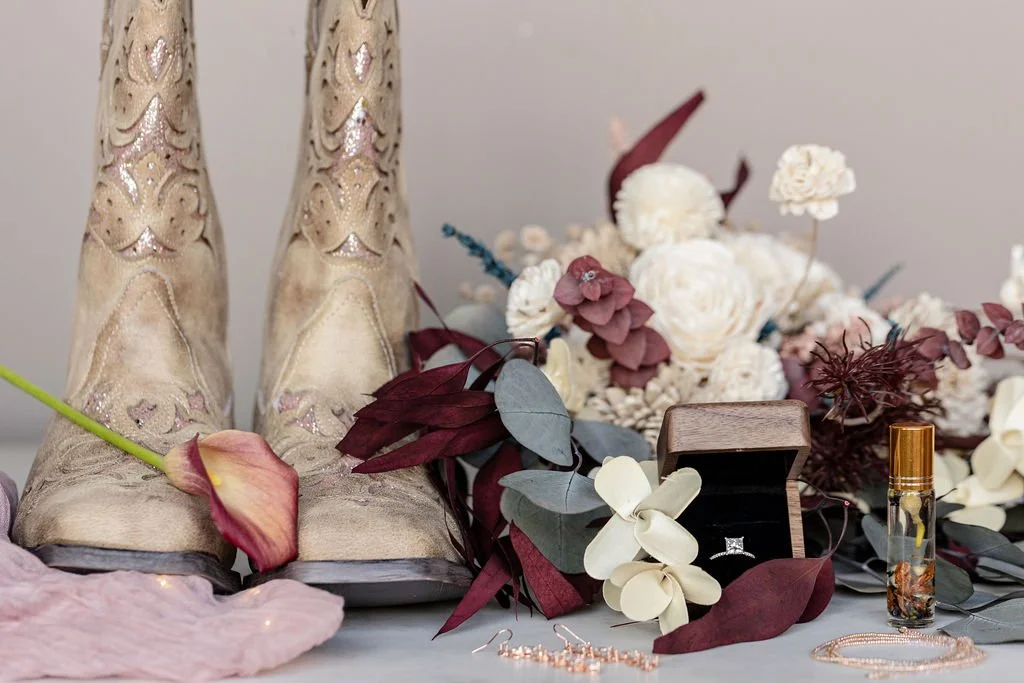 wedding details cowboy boots, flowers,