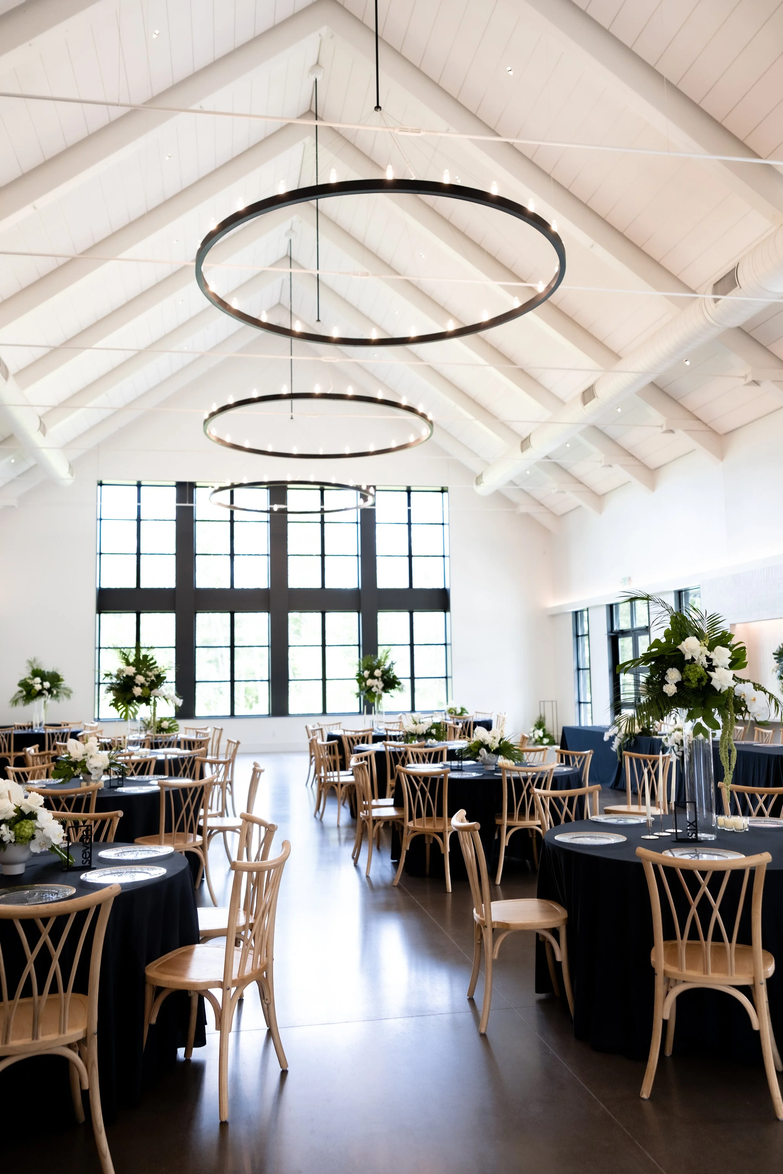 Wedding  set up with floral arrangements and chairs outdoors.