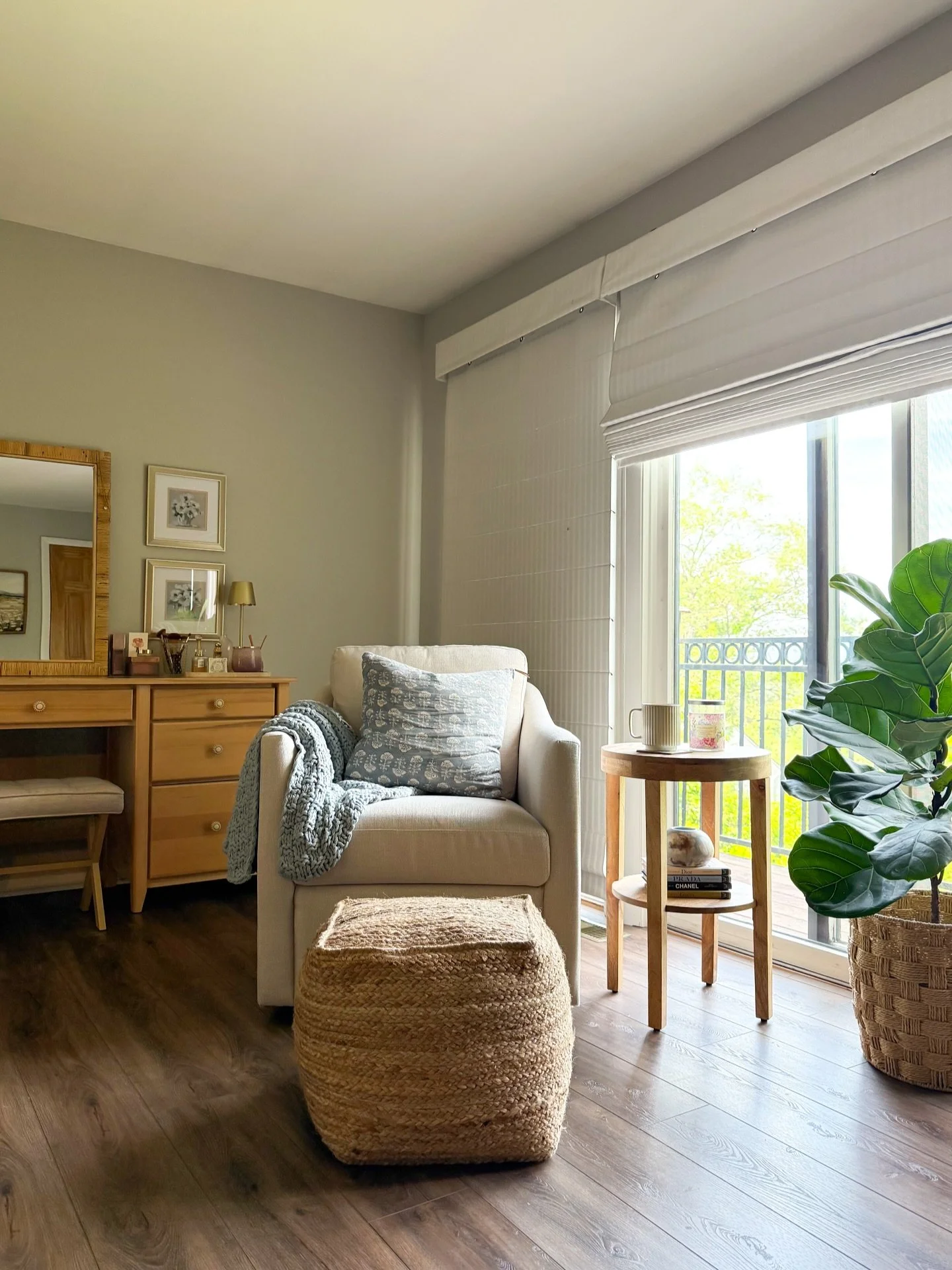 This cozy corner of the homeowner&rsquo;s bedroom underwent a beautiful transformation. By introducing lighter tones, layering in a variety of textures and the addition of greenery in the room, we created a calming space that feels both intentional a