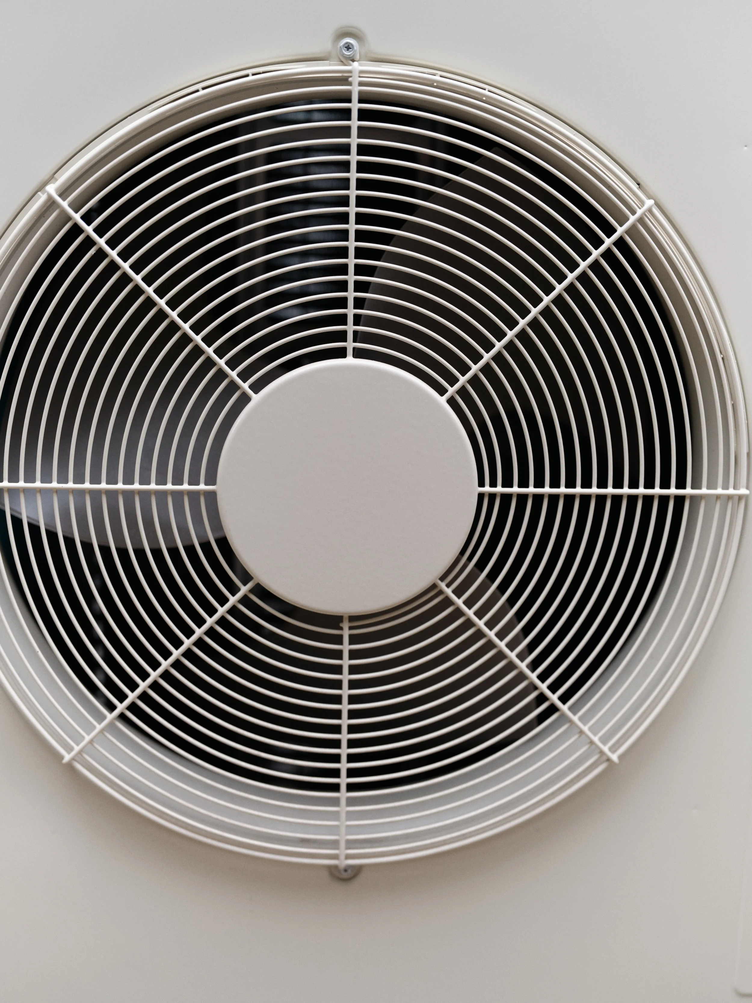 residential air conditioner condenser fan requiring seasonal maintenance and inspection in Orange County HVAC system