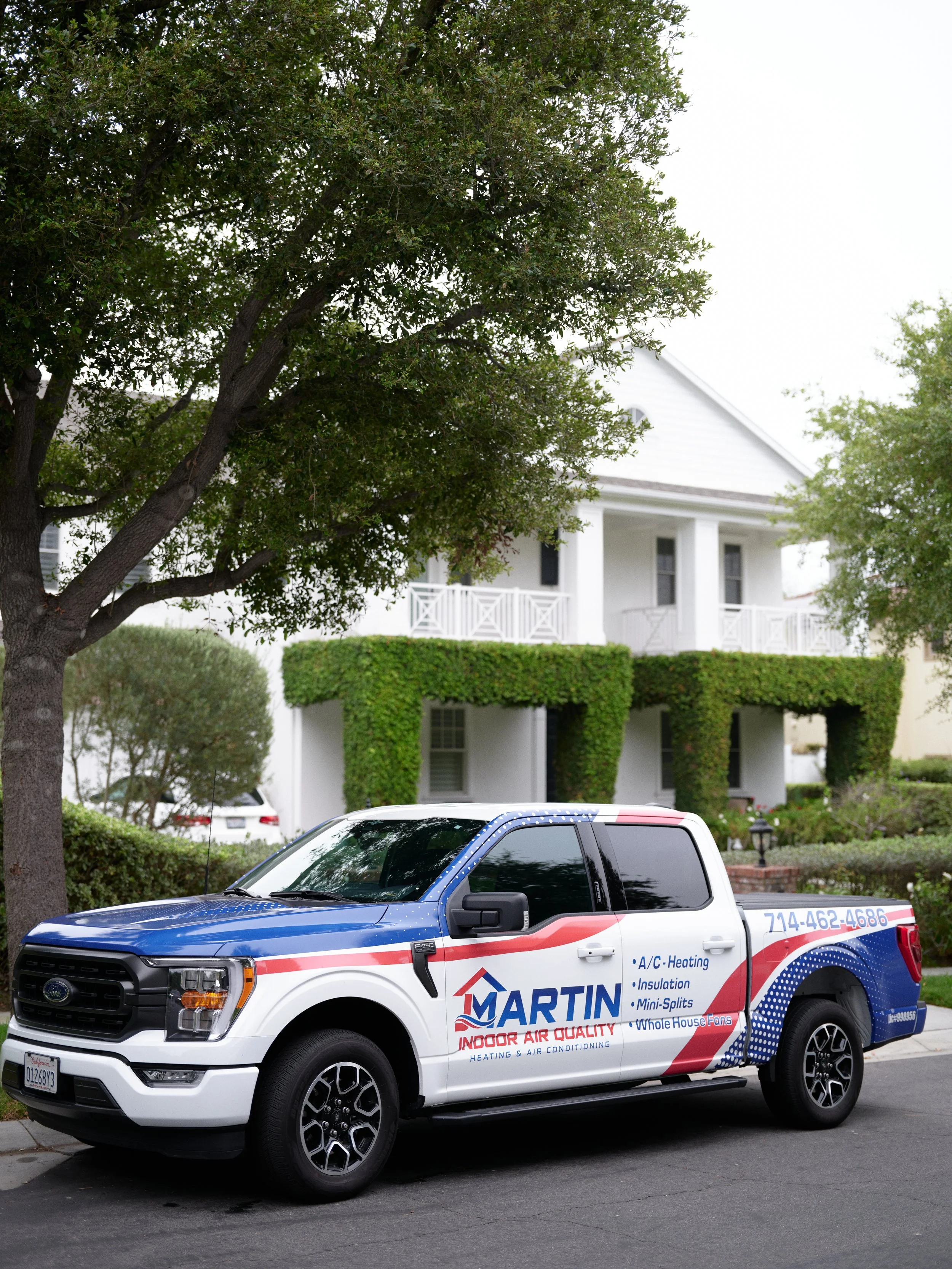 J Martin Indoor Air Quality HVAC service truck parked outside a residential home in Orange County