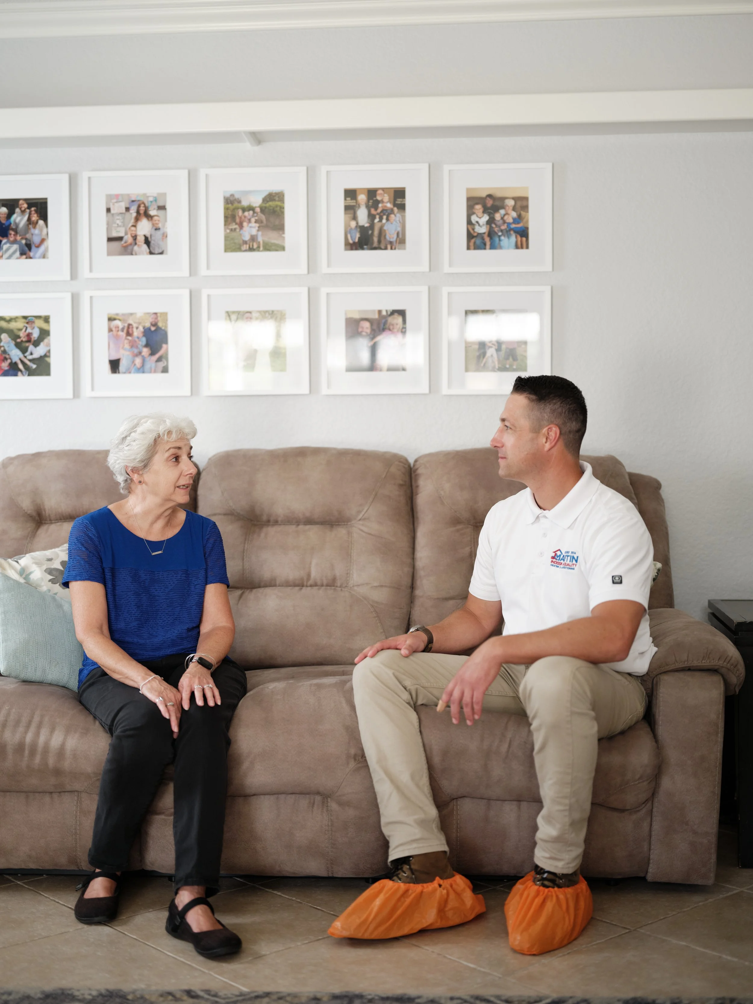HVAC technician discussing service options with homeowner during in-home consultation in Orange County