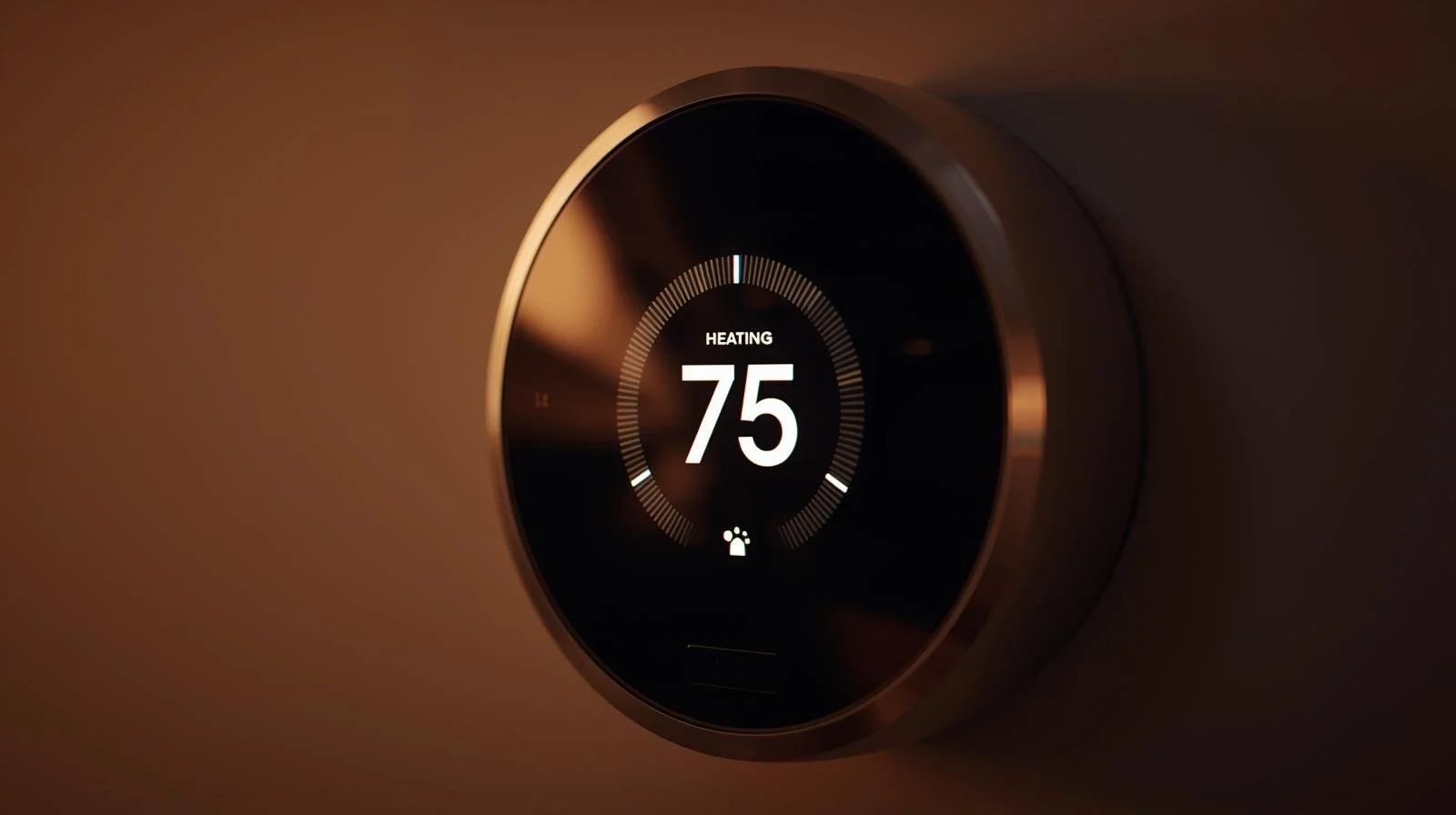 Smart thermostat displaying 75 degrees in heating mode during first winter startup