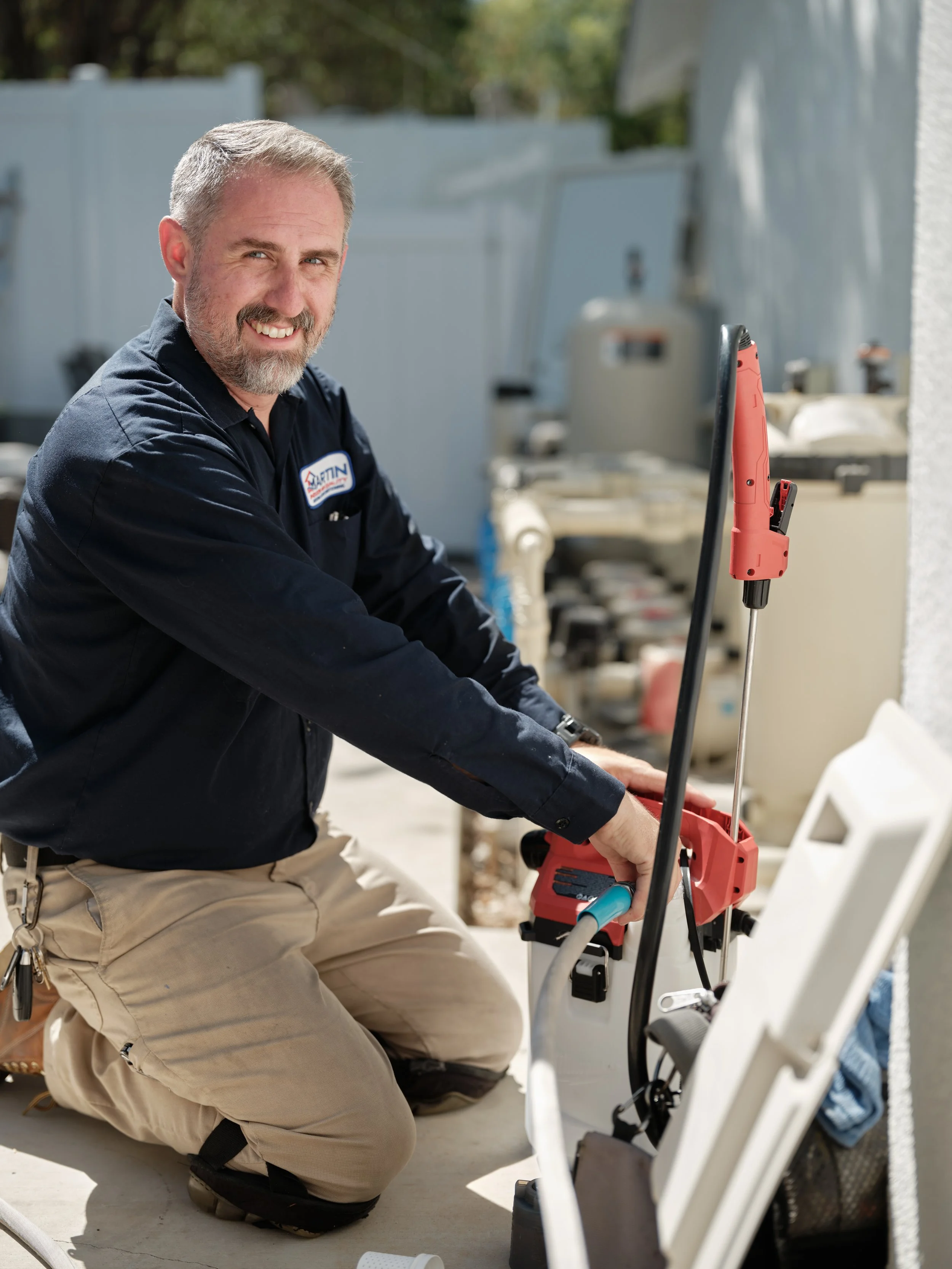 friendly HVAC technician performing rooftop air conditioning maintenance in Santa Ana Orange County