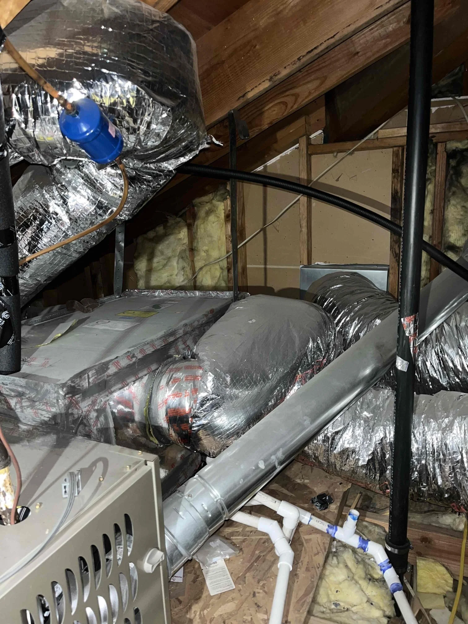 Attic HVAC system with ductwork and furnace showing air circulation and indoor air quality components