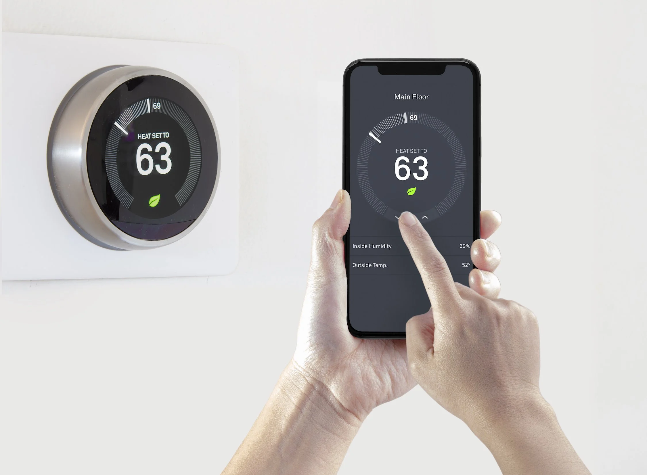 smart thermostat being adjusted from smartphone app to manage home HVAC energy use