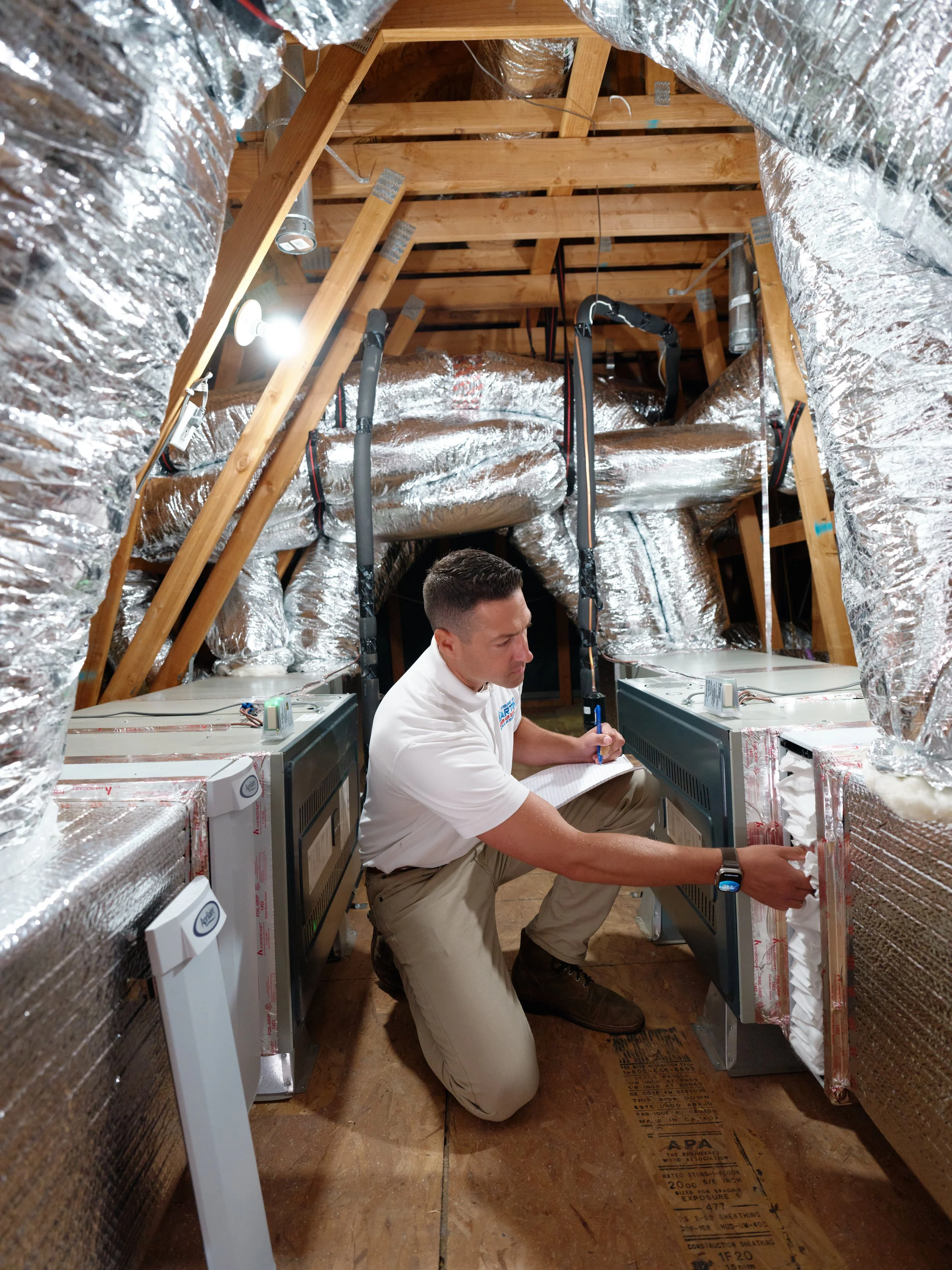 licensed HVAC technician performing attic inspection in Villa Park home