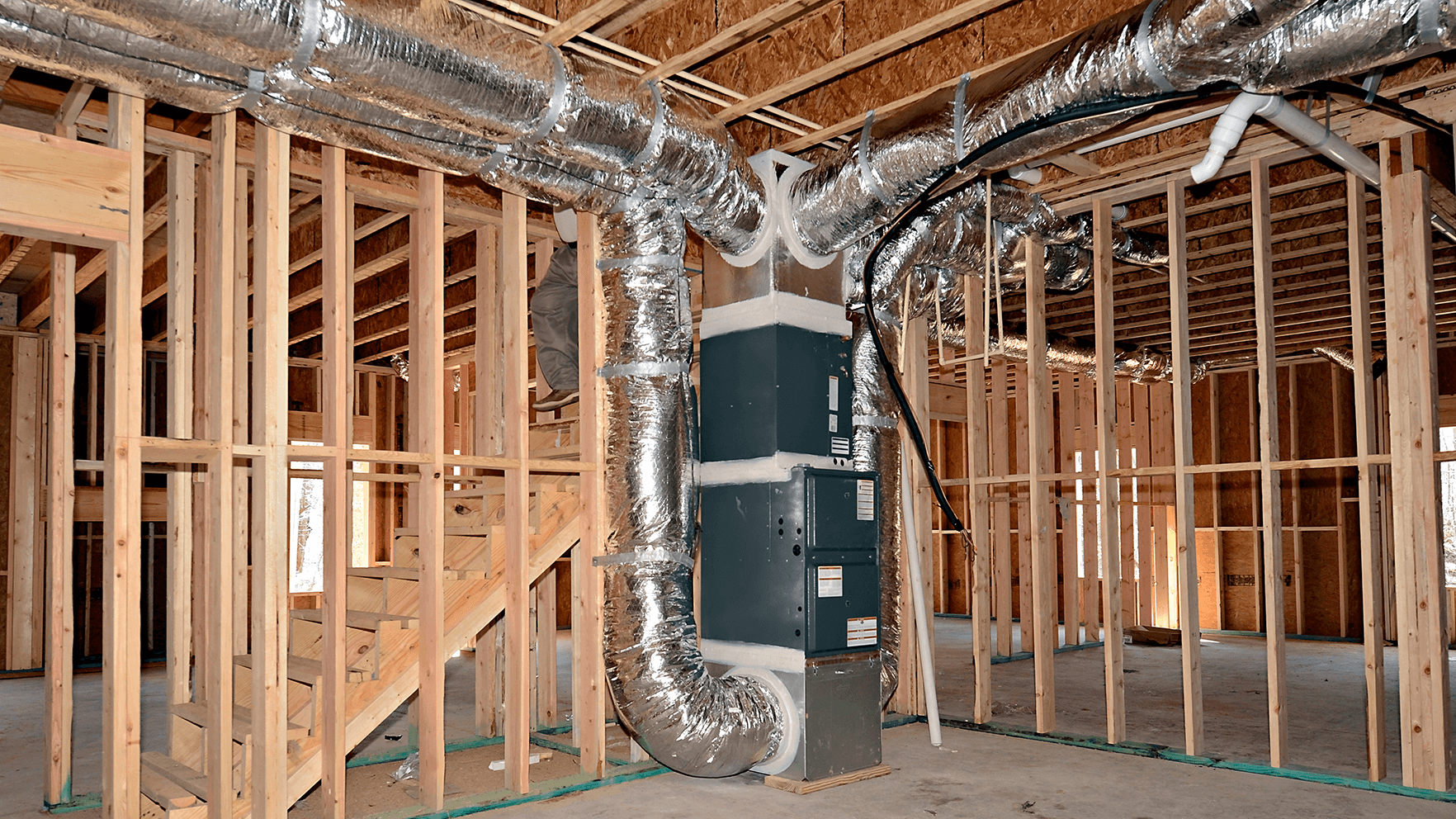 new construction HVAC ductwork installation in framed home showing insulated air ducts and system layout