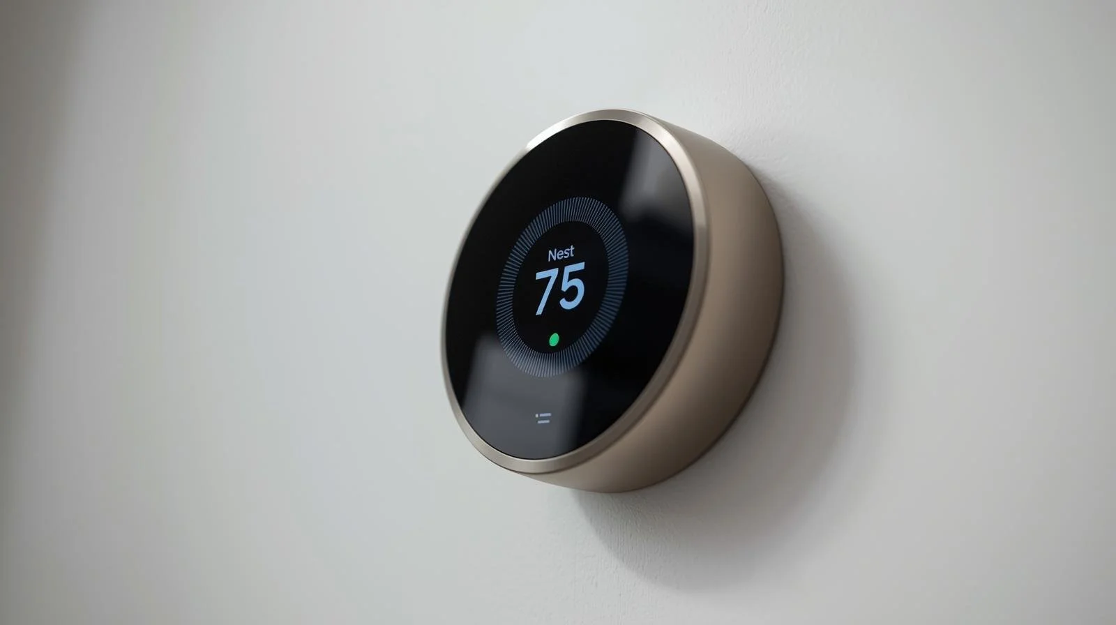 Nest smart thermostat displaying 75 degrees mounted on white wall showing clean professional installation in California home