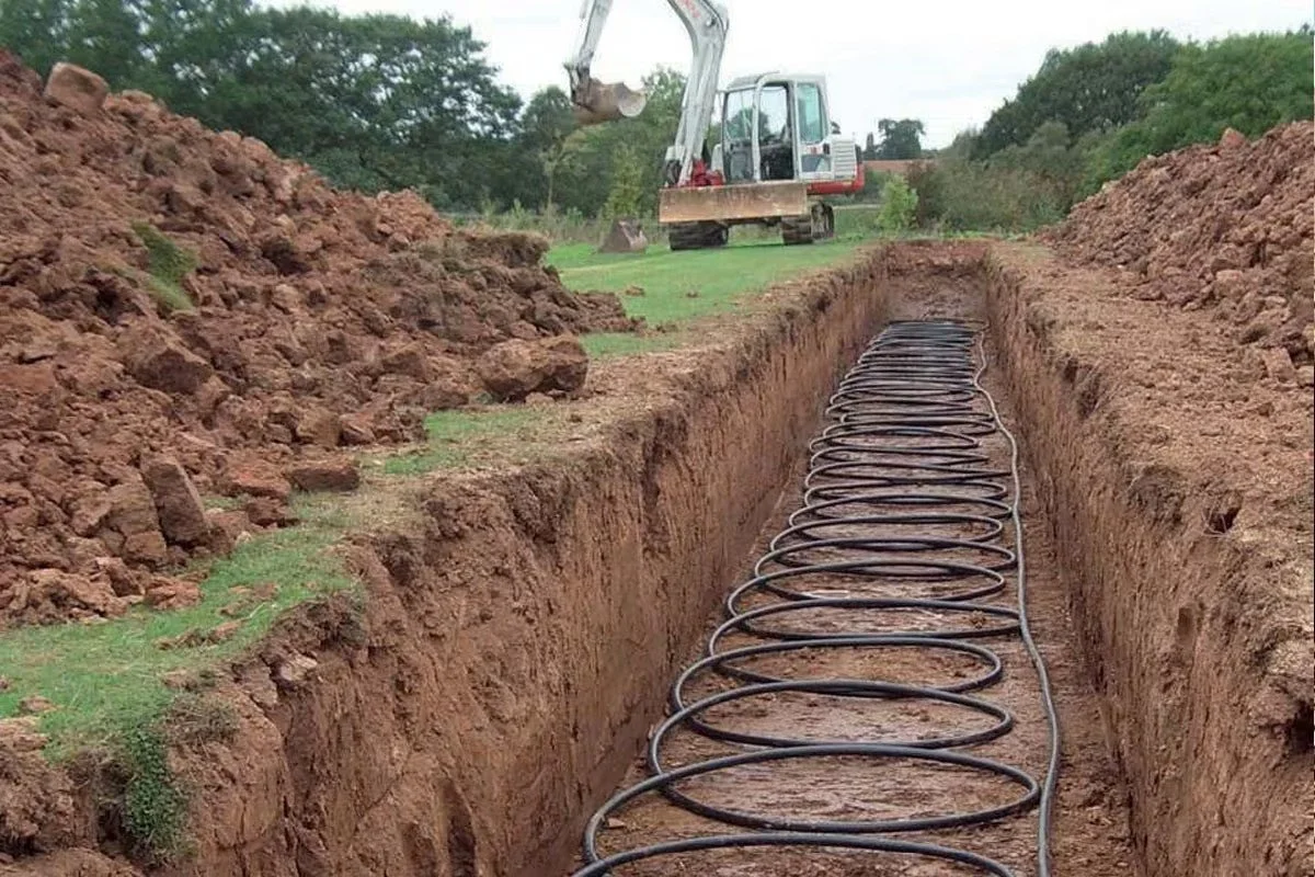 geothermal ground loop coil being installed in a trench, illustrating the residential clean energy equipment covered under the former Section 25D federal tax credit