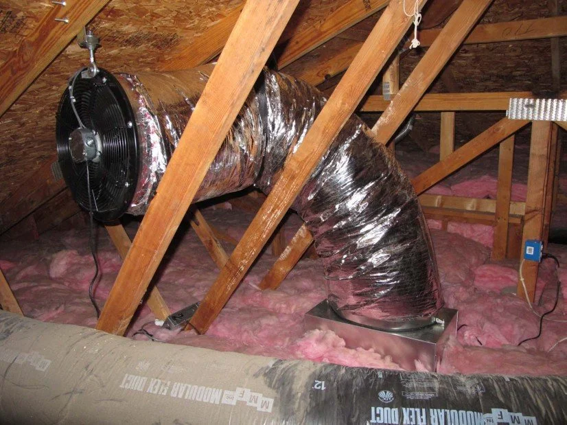 whole house fan installed in attic with insulated ductwork for home ventilation