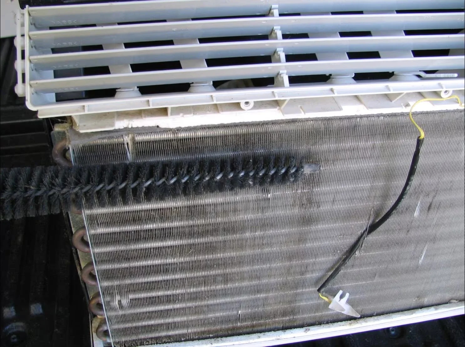 Dirty evaporator coil with mold and debris buildup causing mildew smell in air conditioner