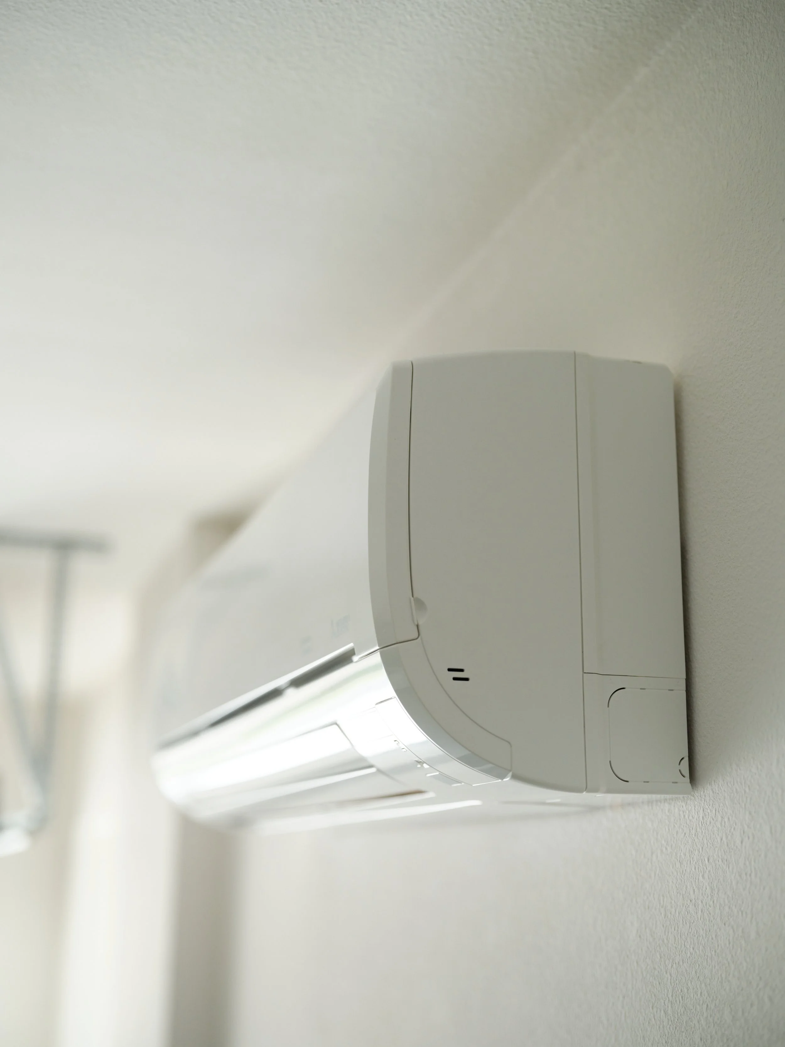 wall-mounted ductless mini-split heat pump providing independent cooling for upstairs bedroom in Orange County home