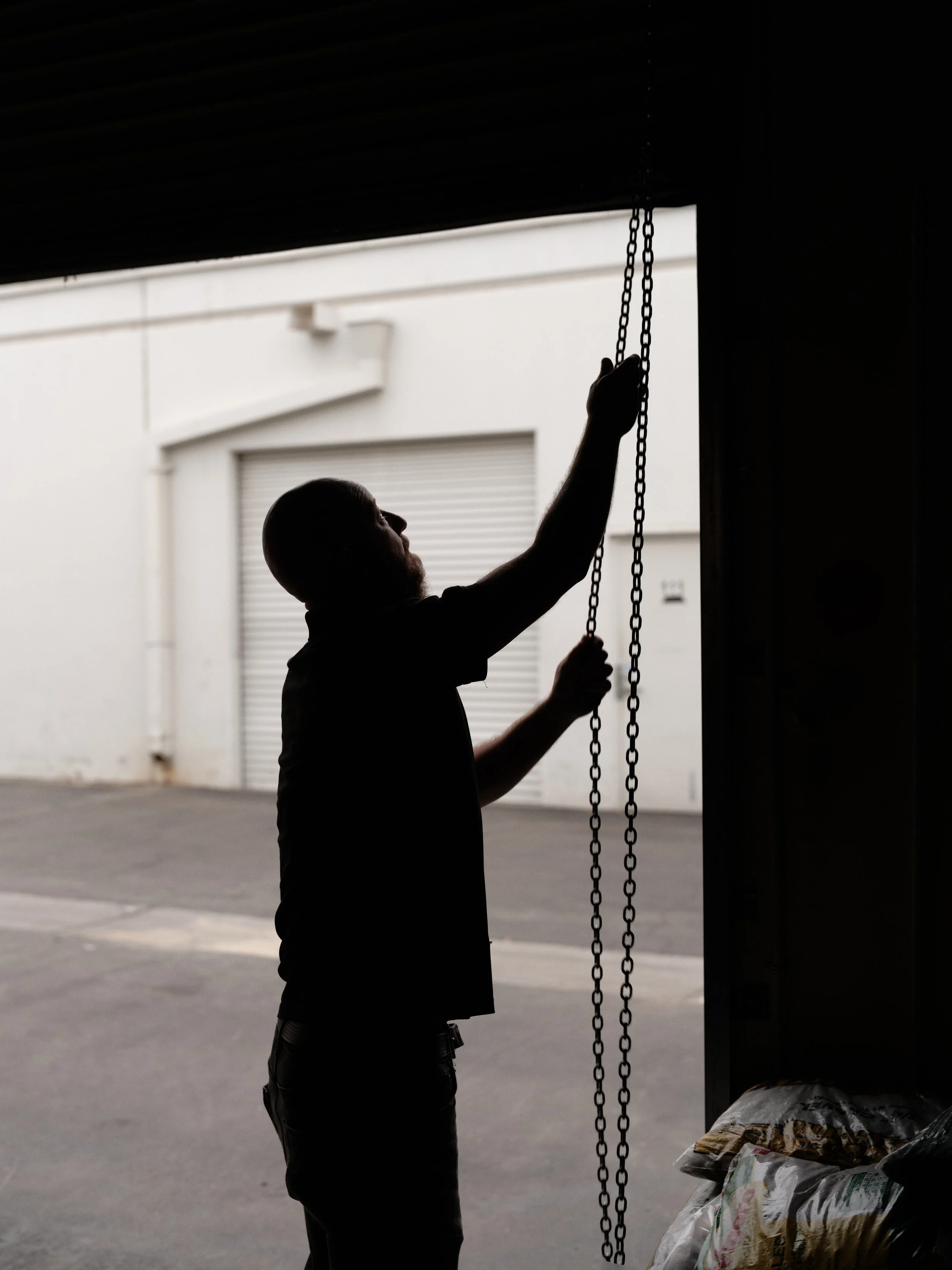 silhouette of HVAC technician working hands-on with equipment at local home