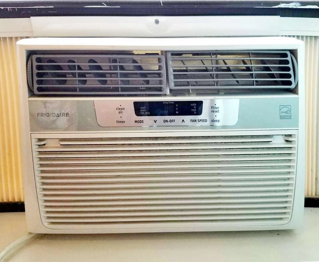 Window AC unit used as supplemental cooling in an Anaheim Hills home with an undersized central air conditioning system
