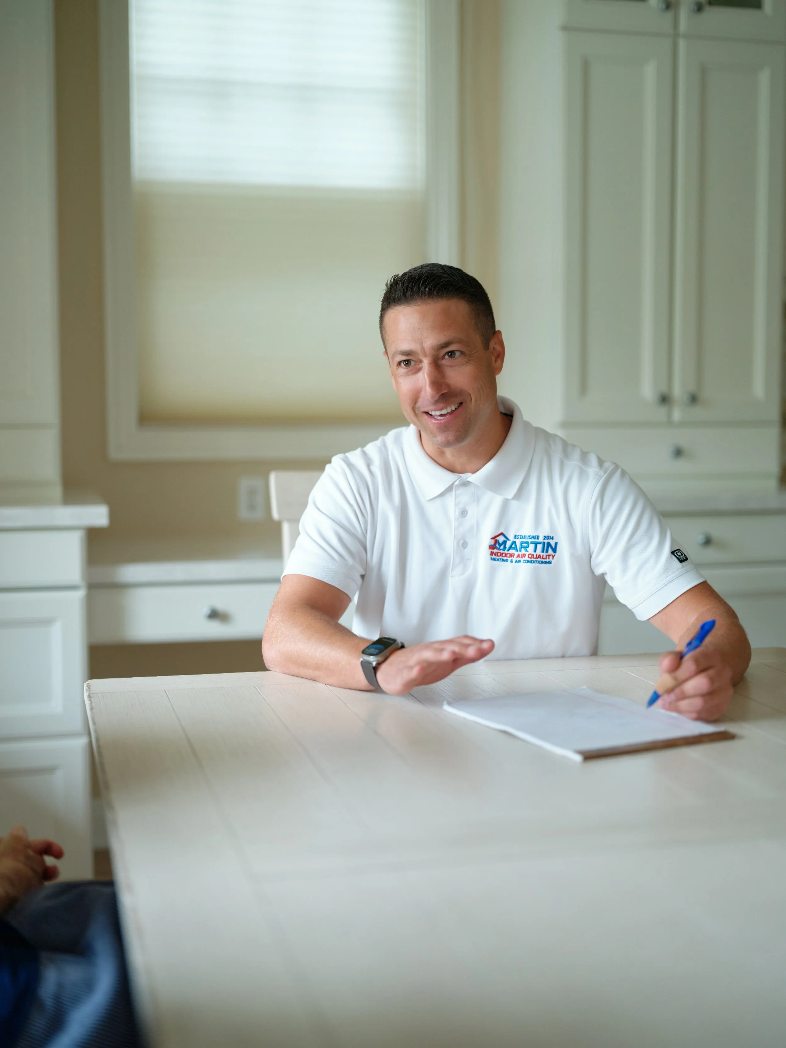 J Martin HVAC technician providing transparent maintenance consultation to Orange County homeowner