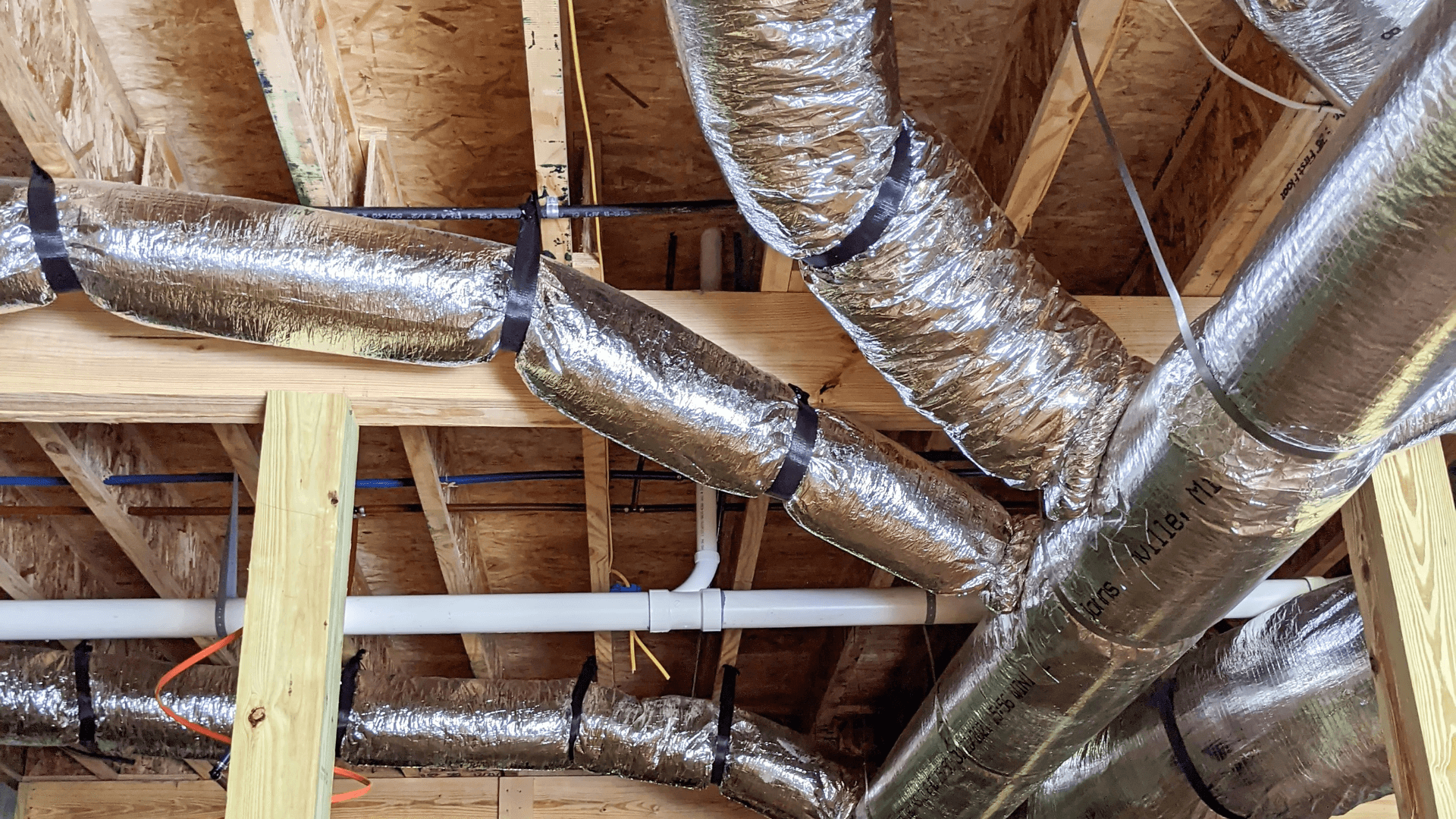 insulated HVAC ductwork in attic showing home air distribution system and airflow efficiency