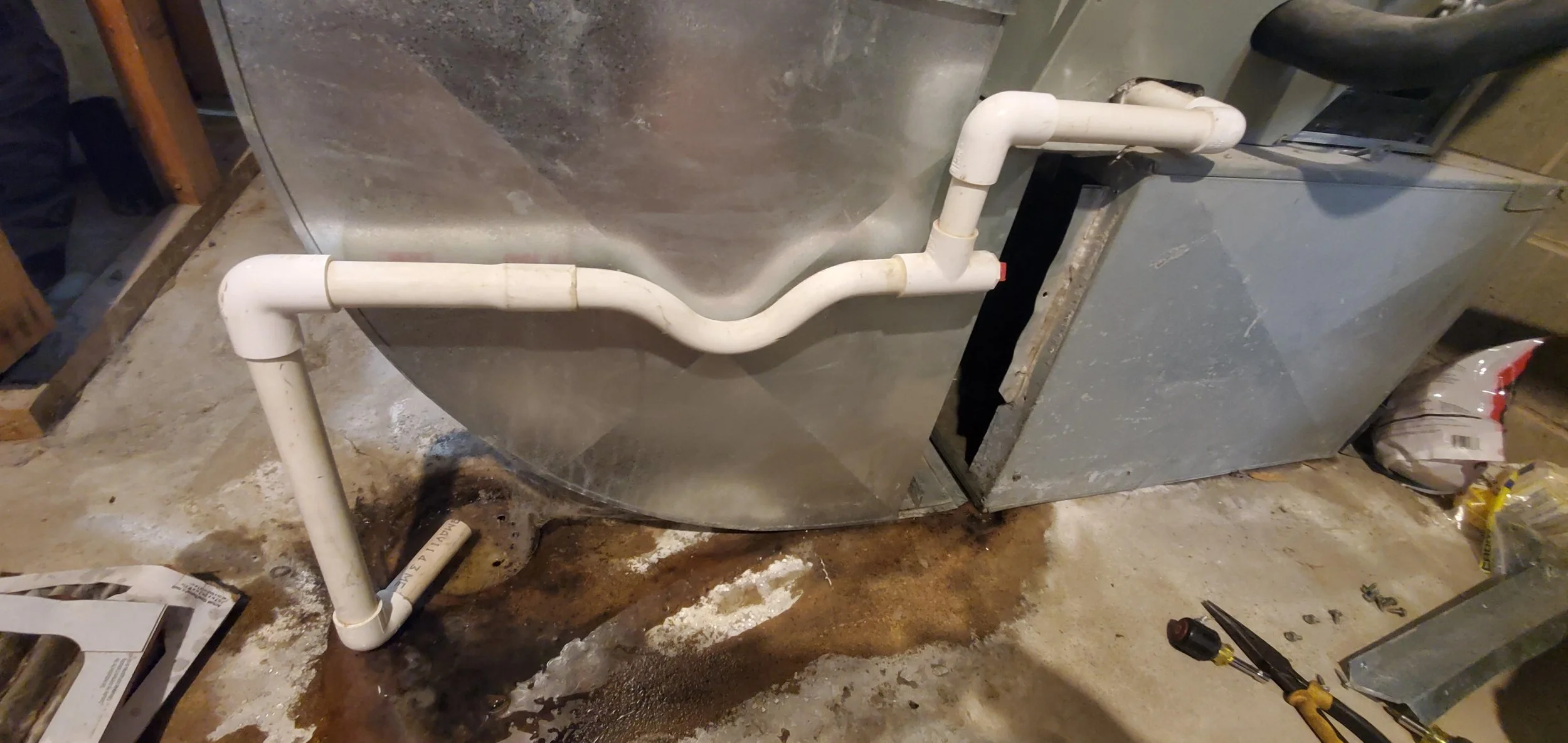 Water pooling under air handler from clogged AC condensate drain line
