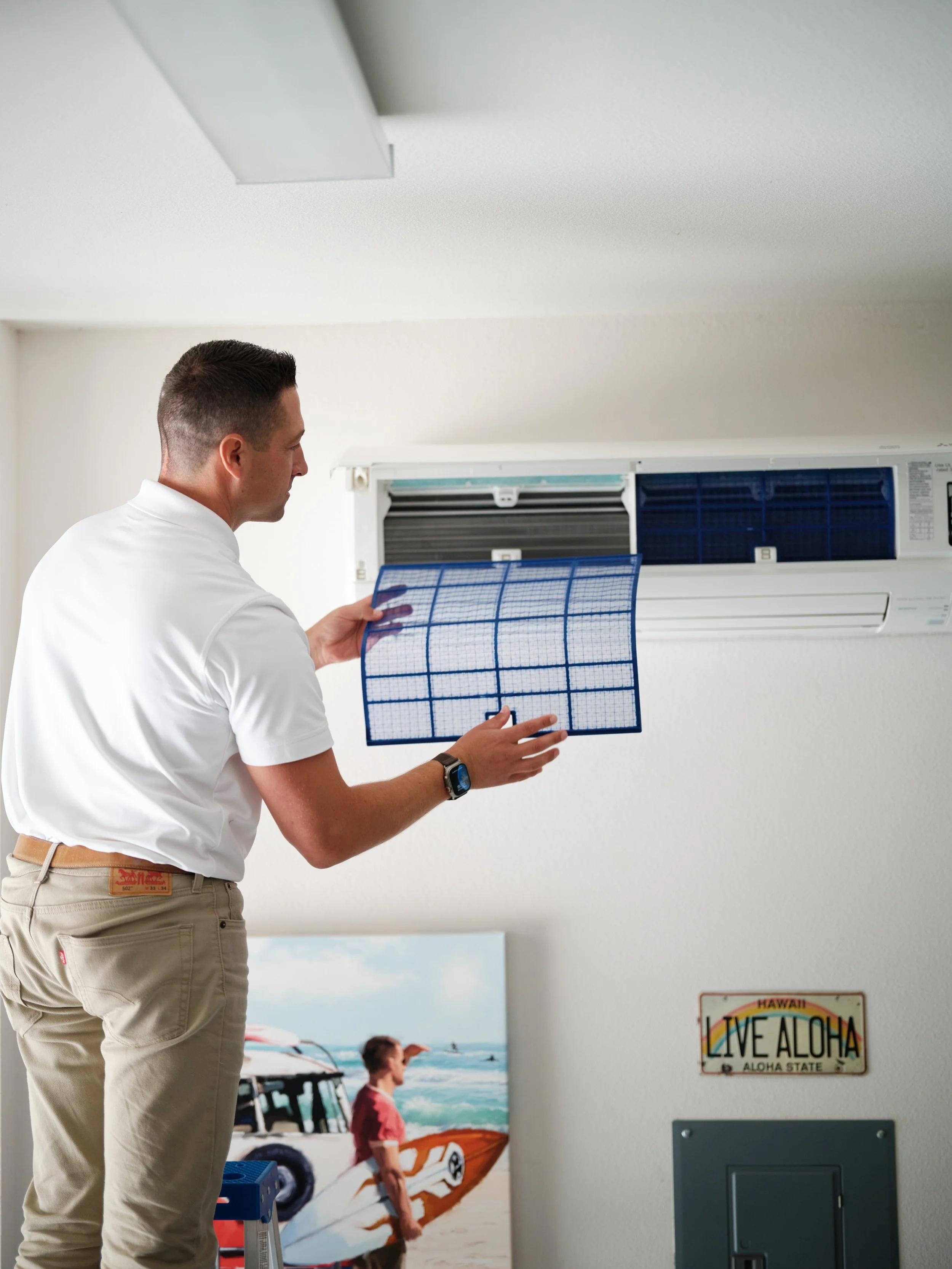 homeowner cleaning mini split air conditioner filter to improve indoor air quality and system efficiency