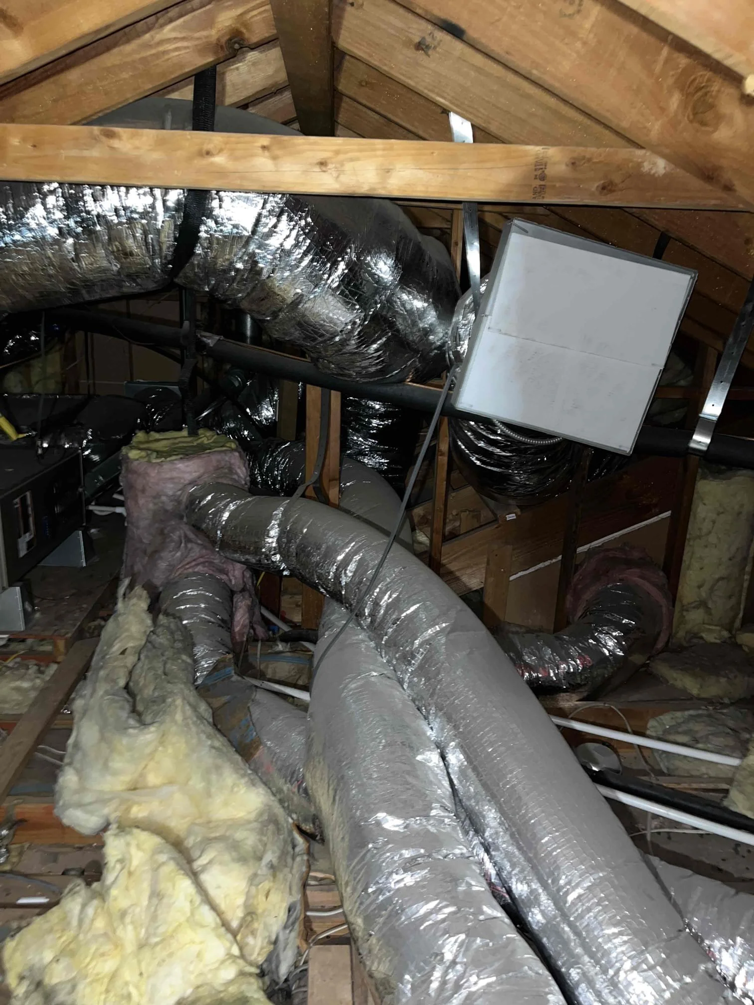 Old attic duct system with deteriorated insulation in Orange County home requiring evaluation before HVAC replacement in 2026