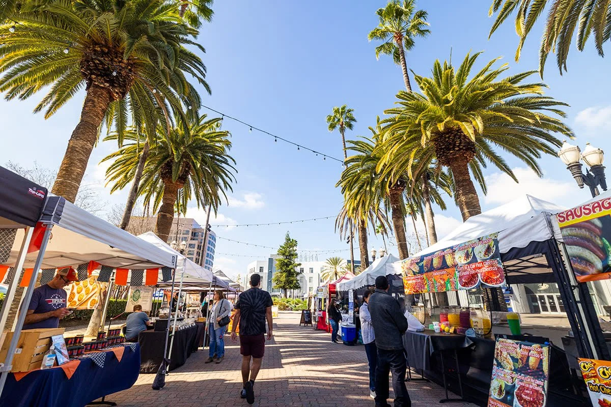 sunny summer day with palm trees and outdoor market in Anaheim, Orange County California during hot weather
