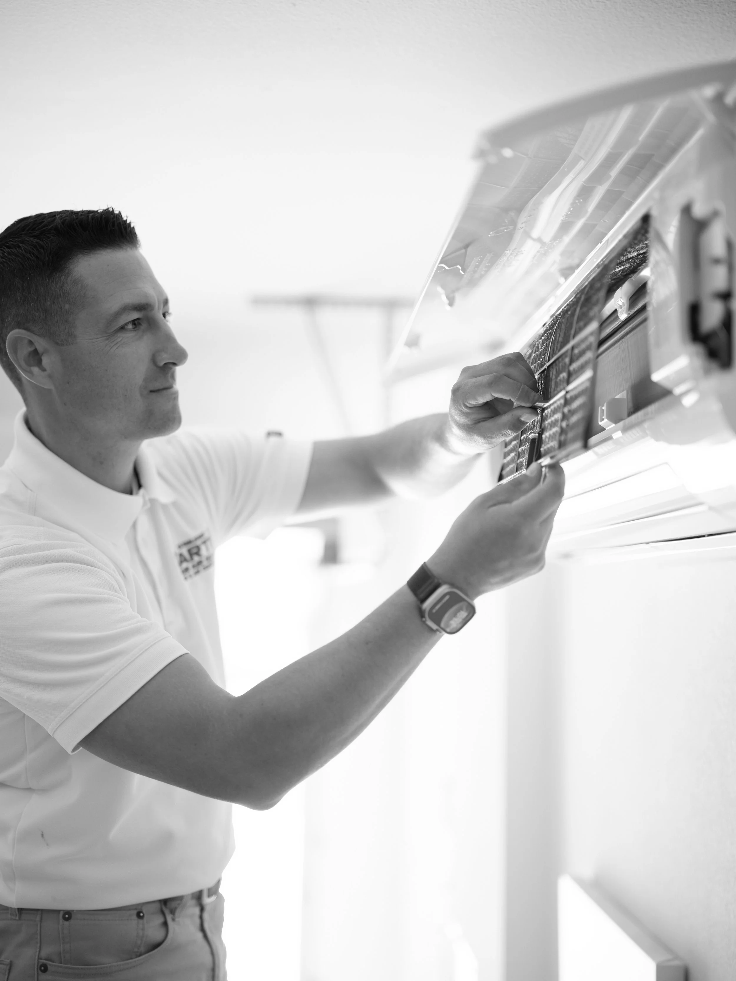 J Martin technician inspecting HVAC system for Orange County homeowner weighing furnace repair against heat pump replacement options