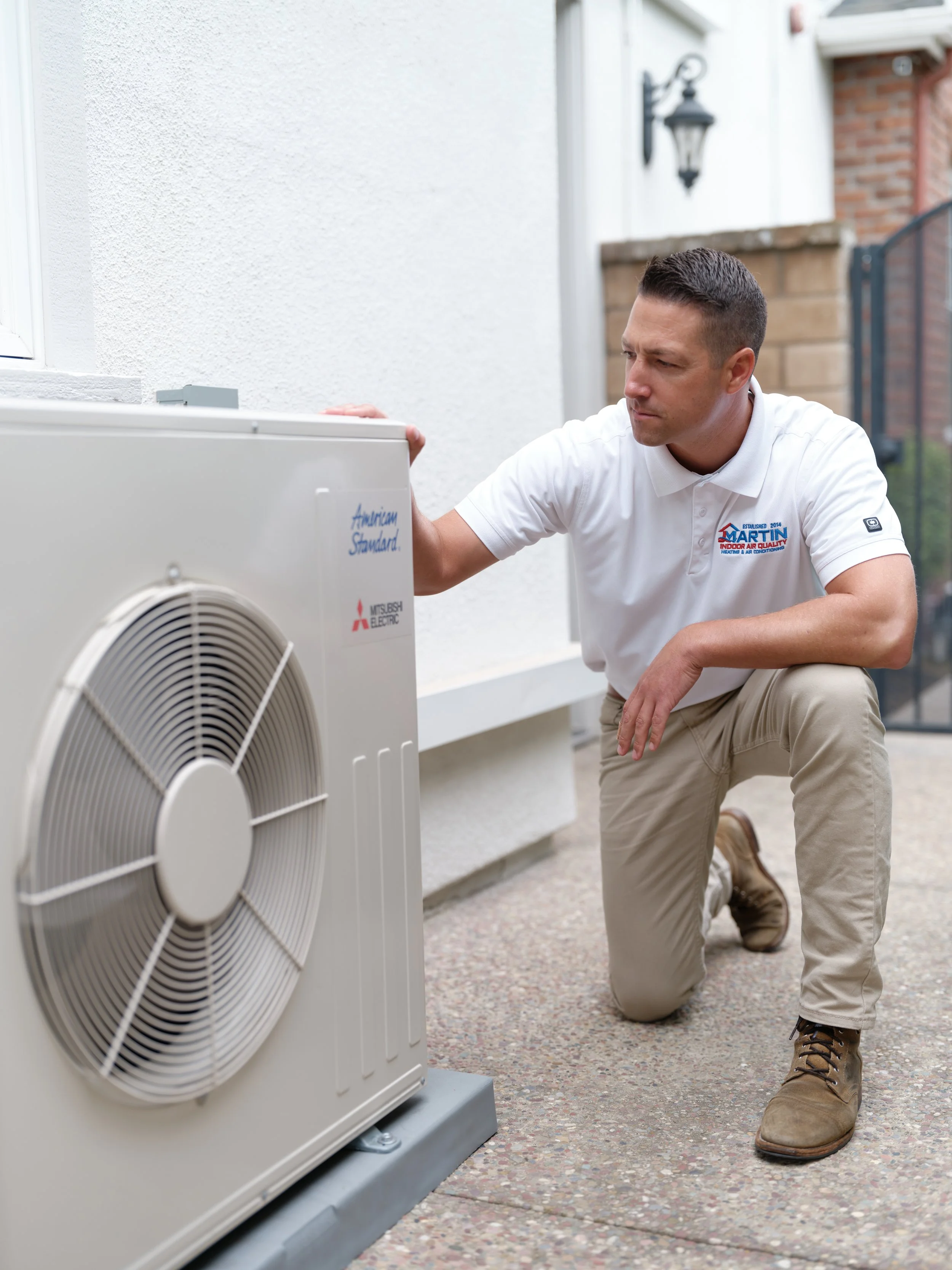 J Martin technician diagnosing outdoor AC unit for short cycling problem in Orange County