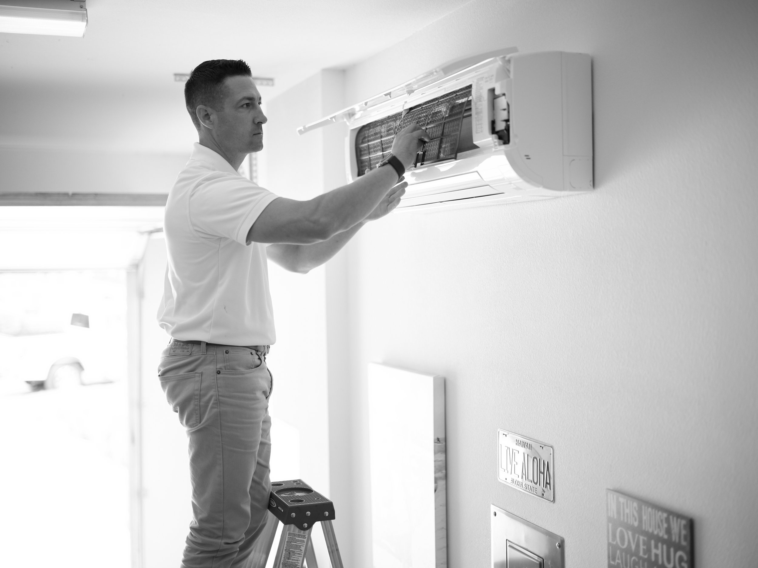 HVAC technician installing mini split wall unit in Yorba Linda home bedroom