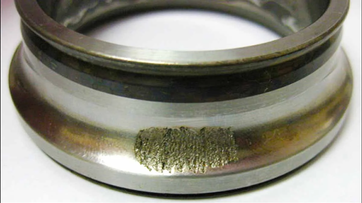 close-up of worn furnace blower motor bearing showing surface damage and wear caught during HVAC maintenance in Orange County